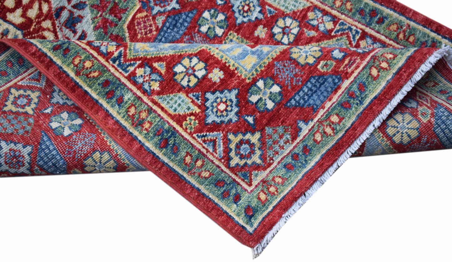 A handmade Afghan Chobi runner featuring a traditional red Mamluk pattern with blue accents.