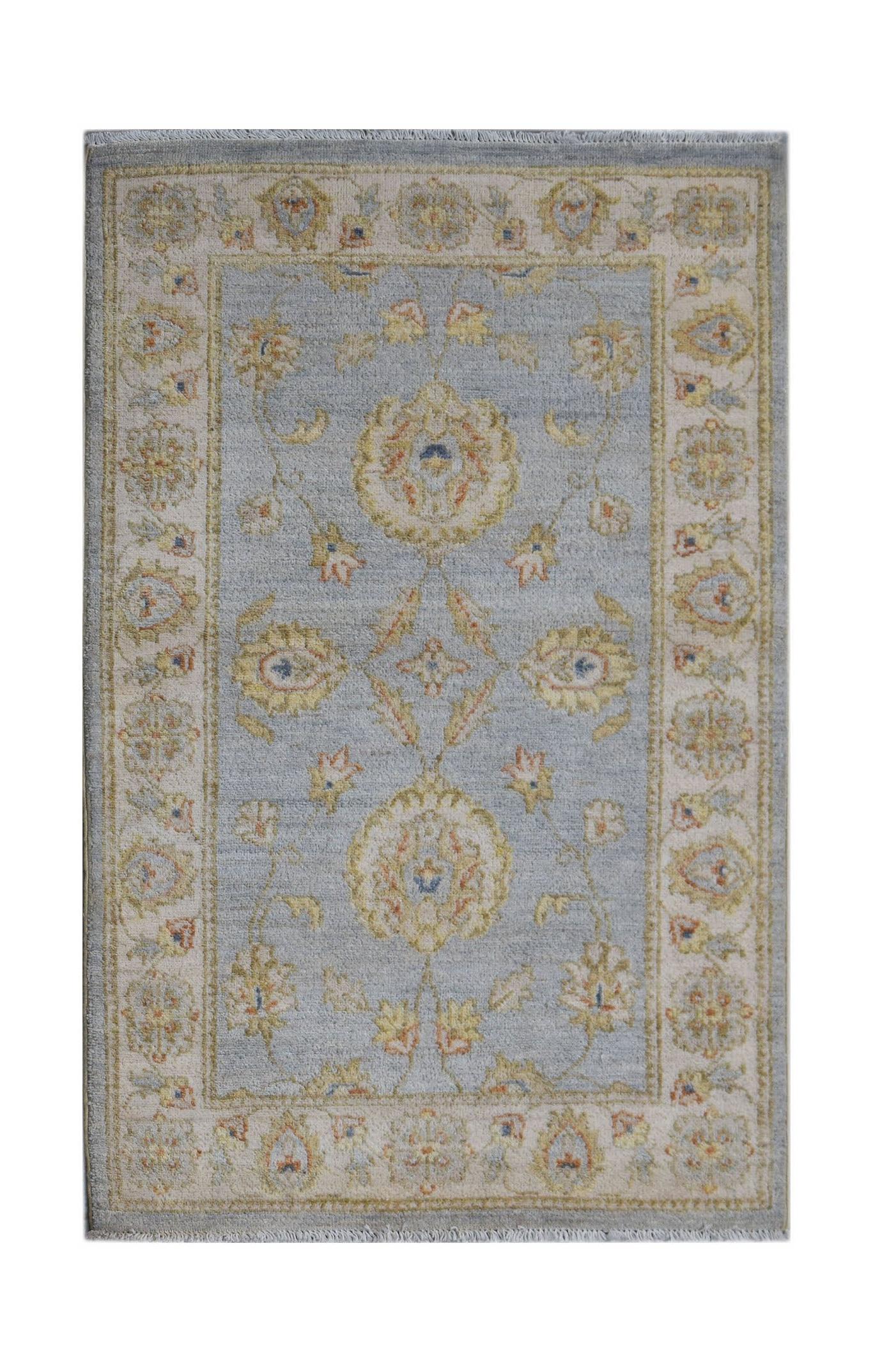 Handwoven Afghan Chobi rug featuring a light blue field with traditional floral patterns.