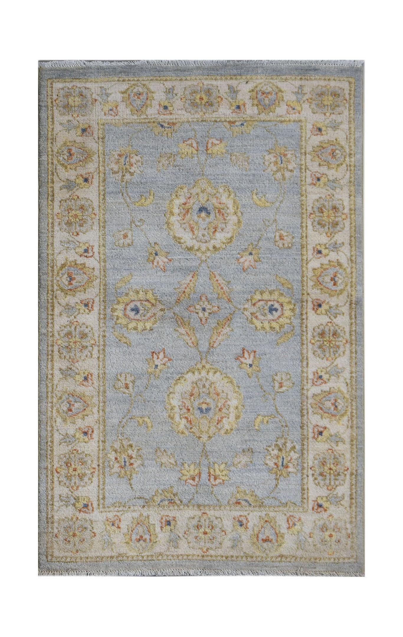 An Afghan Chobi rug featuring a light blue field with traditional floral patterns and a cream border.