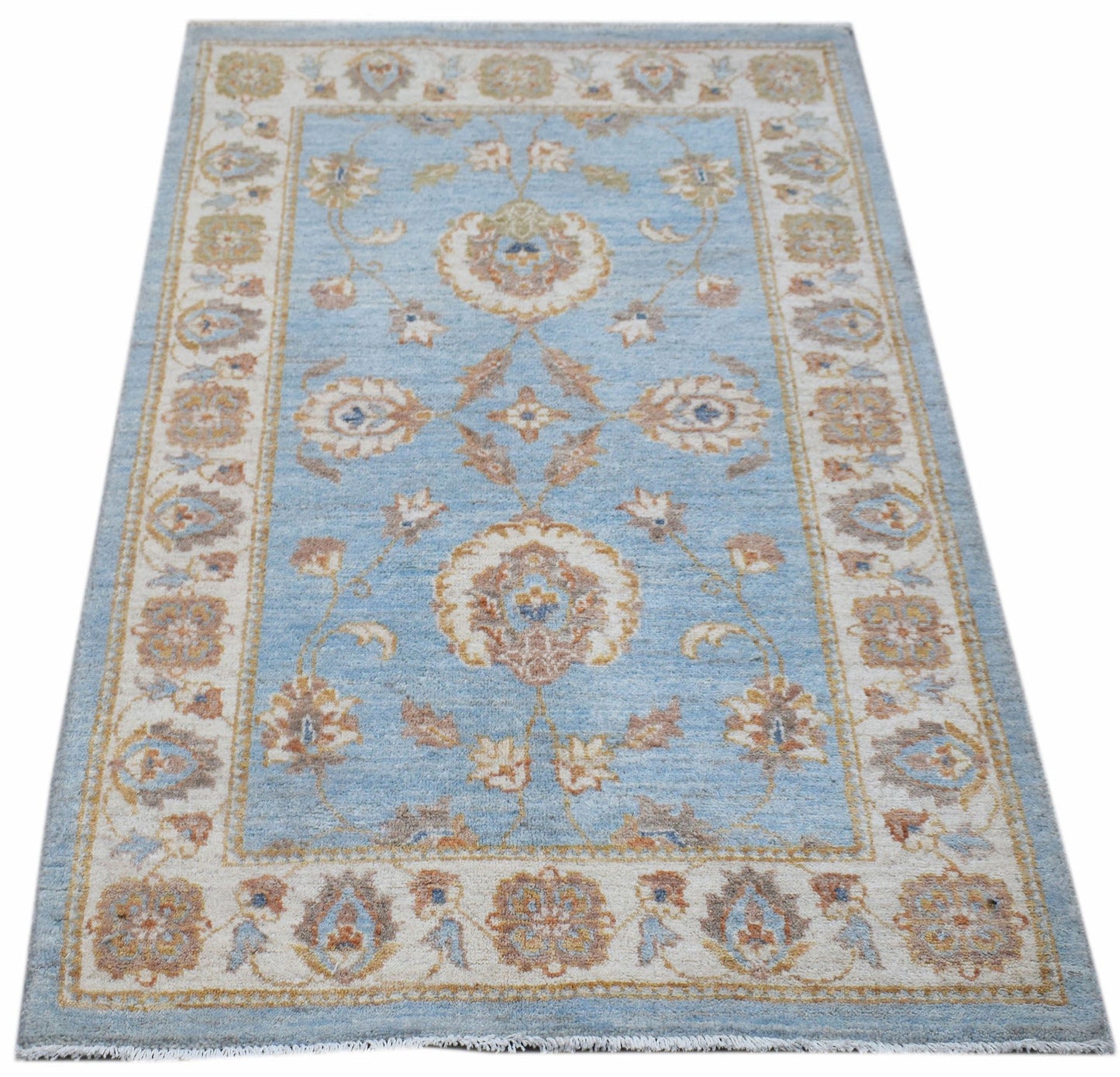 Handwoven Afghan Chobi rug featuring a traditional floral pattern in blue, beige, and brown tones.