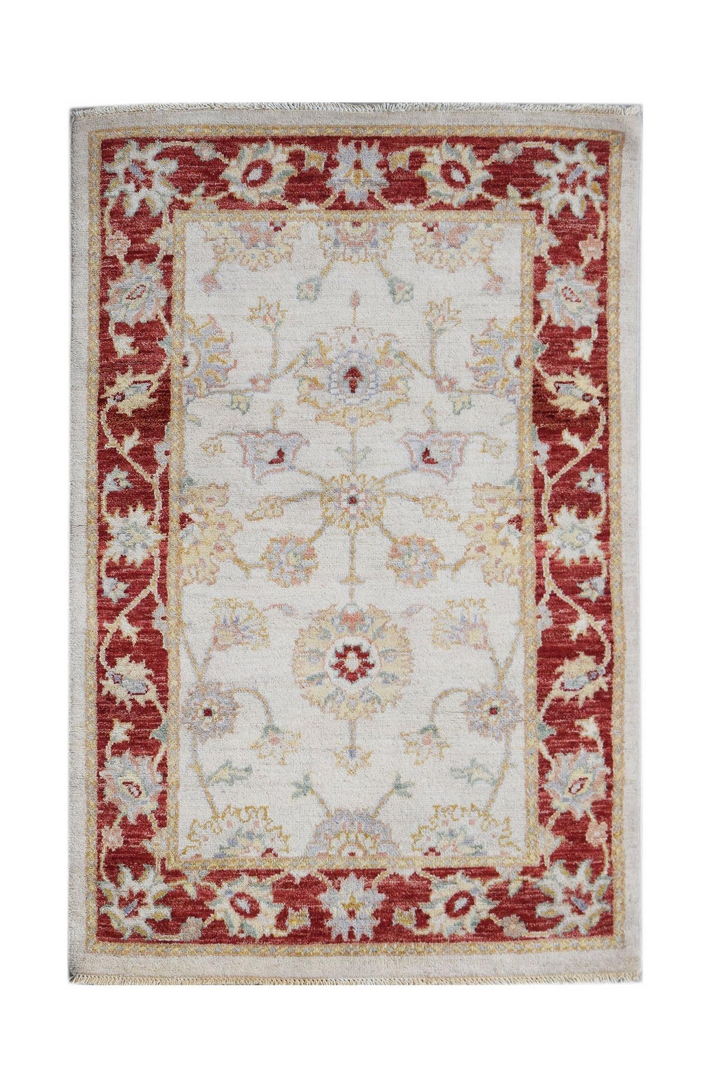 An Afghan Chobi rug featuring a cream field with floral motifs and a deep red border.