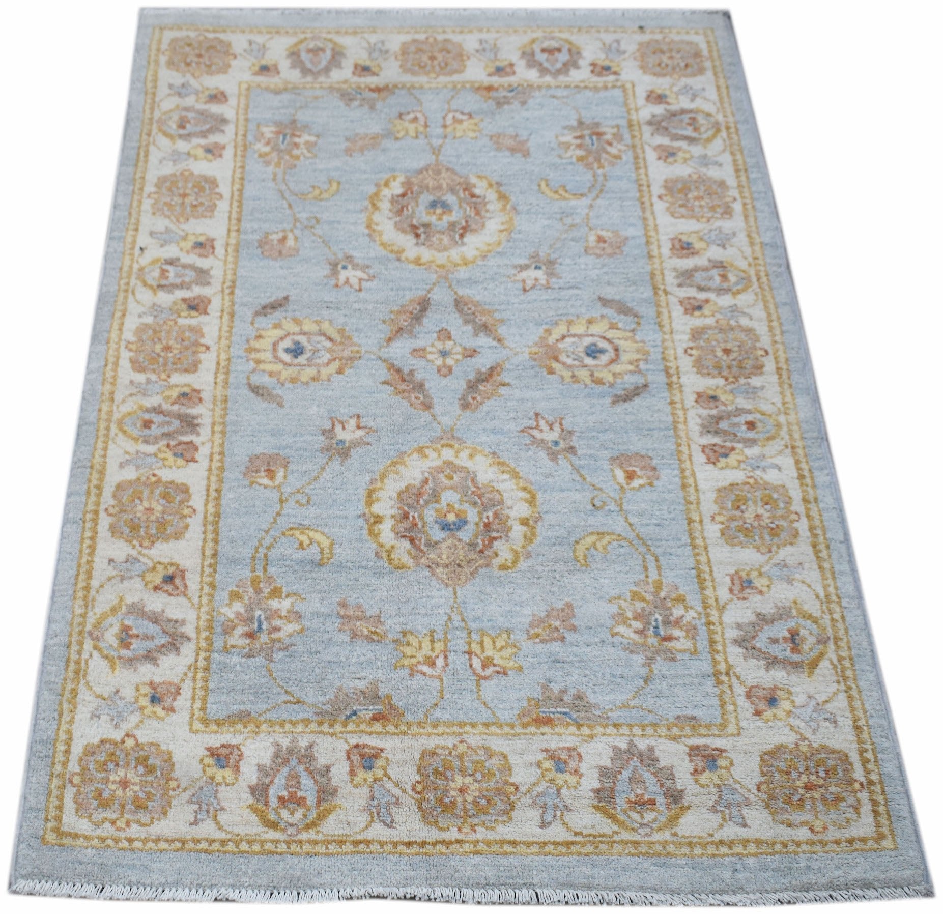 A rectangular Afghan Chobi rug featuring a light blue field with traditional floral patterns.
