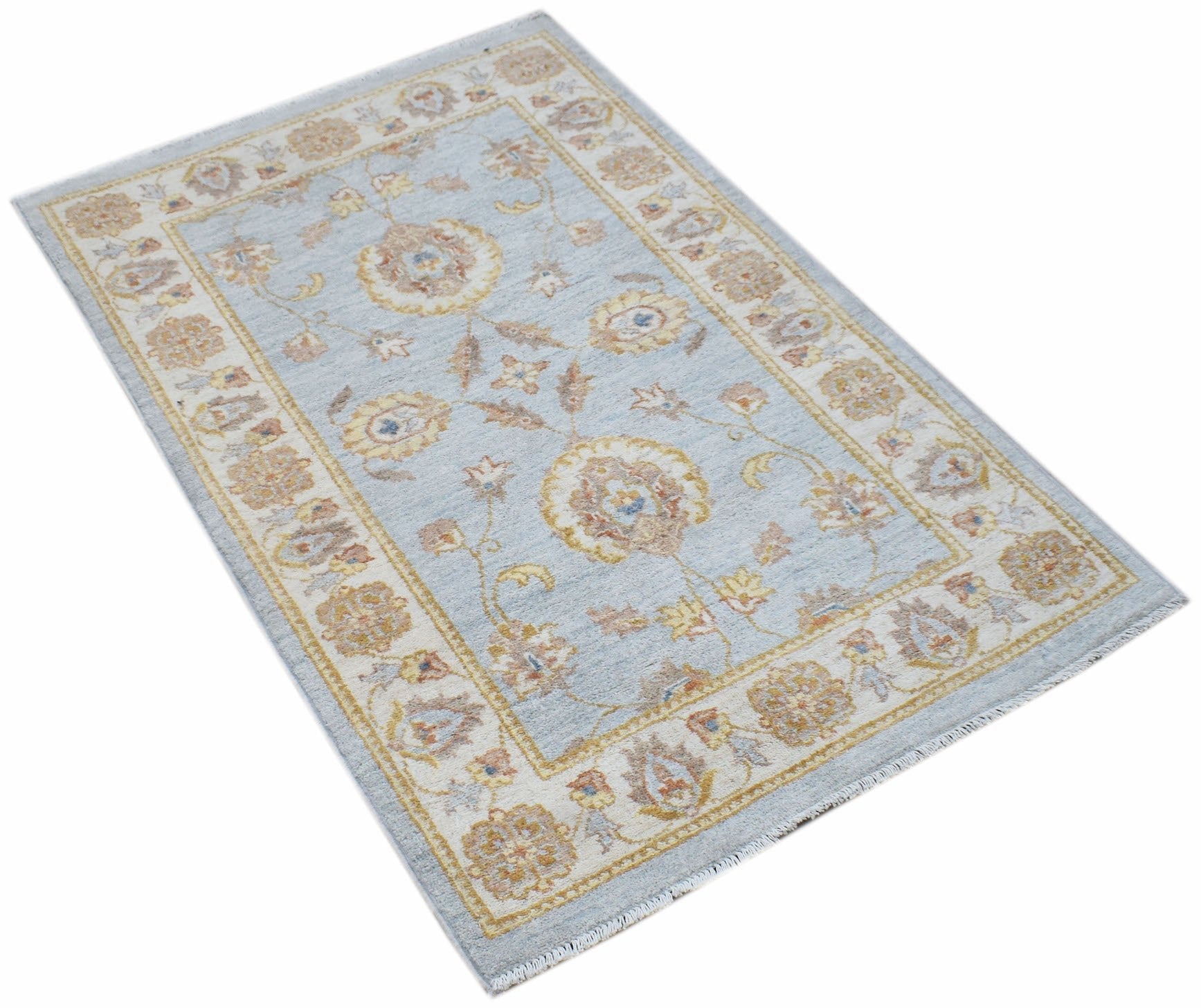 A rectangular Afghan Chobi rug featuring a light blue field with traditional floral patterns.