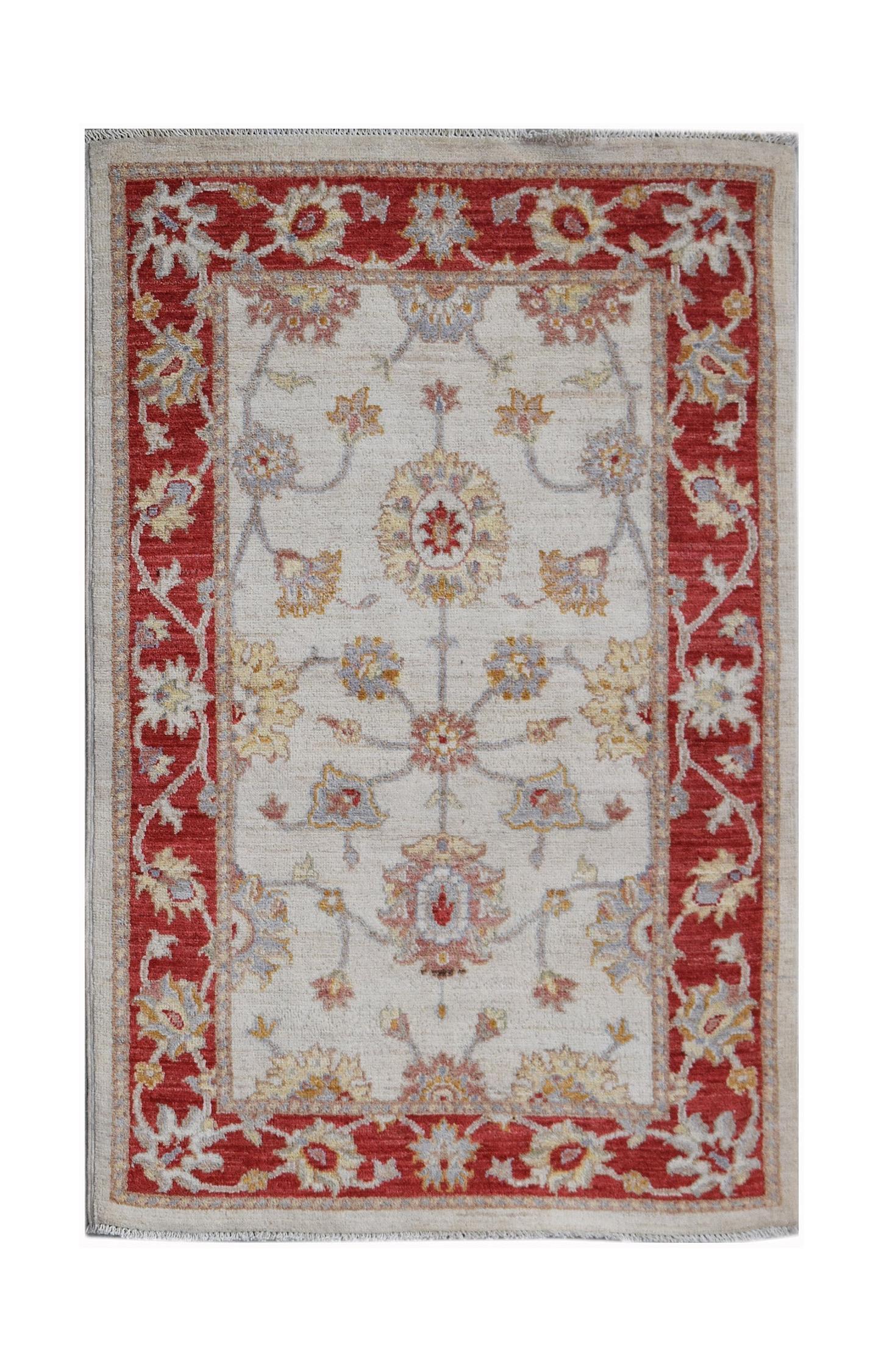 A rectangular Afghan Chobi rug featuring a floral pattern in red, cream, and muted earth tones.