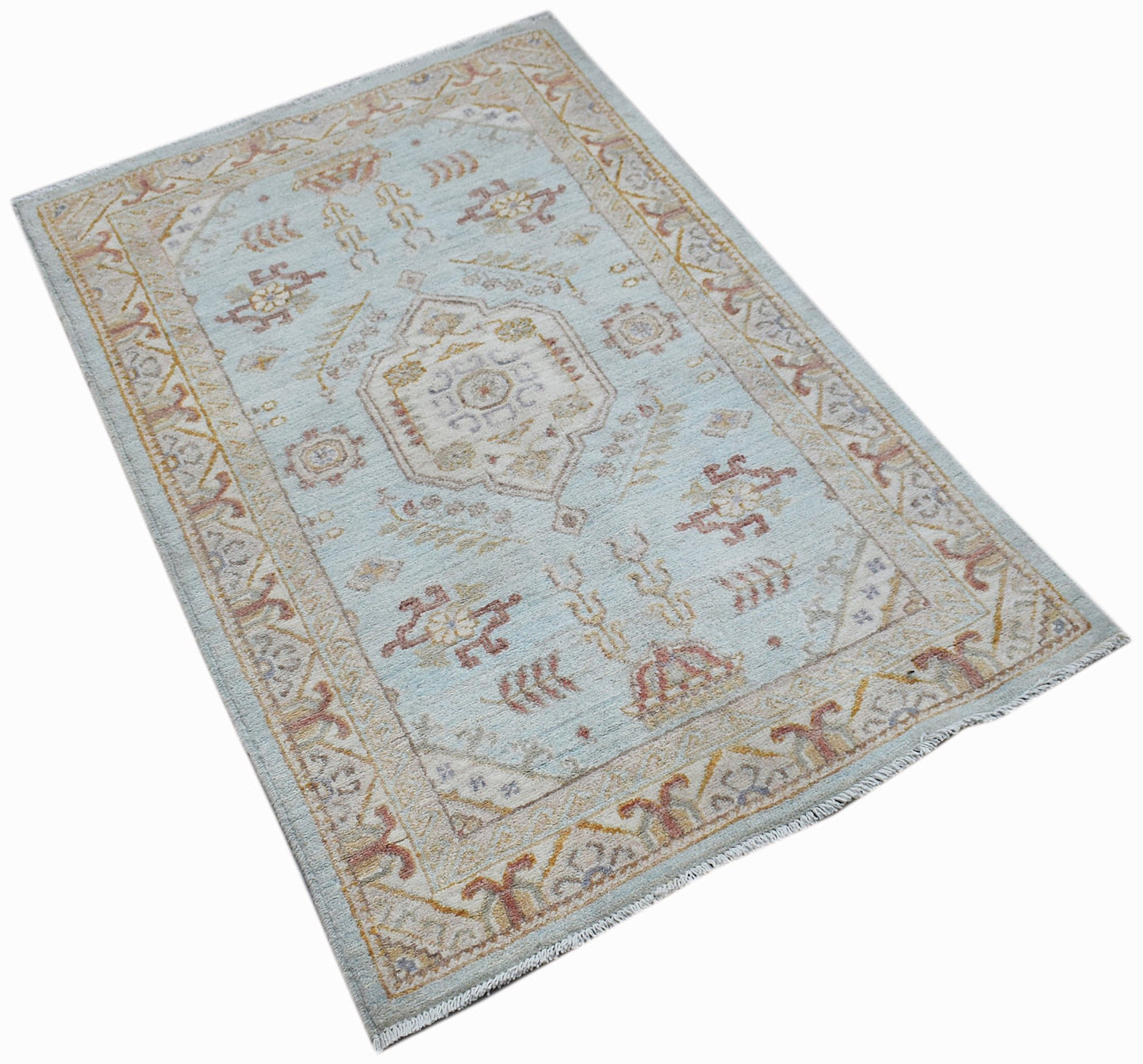 A rectangular Afghan Chobi rug featuring a traditional geometric pattern in soft blue and tan tones.