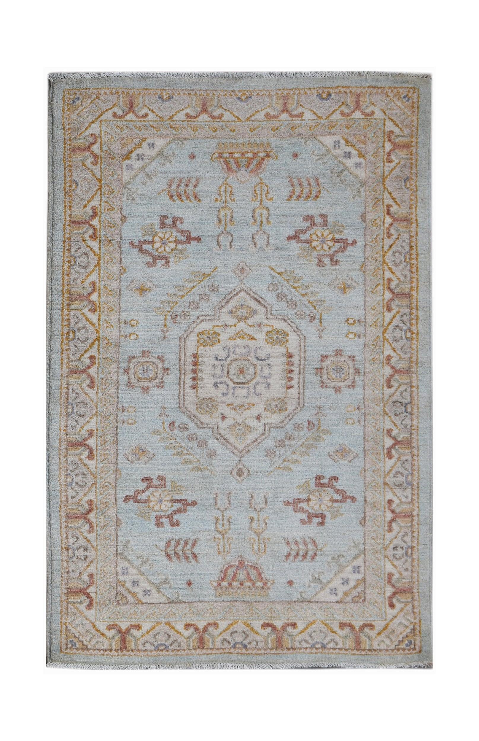 A rectangular Afghan Chobi rug featuring a central medallion on a light blue field with floral motifs.