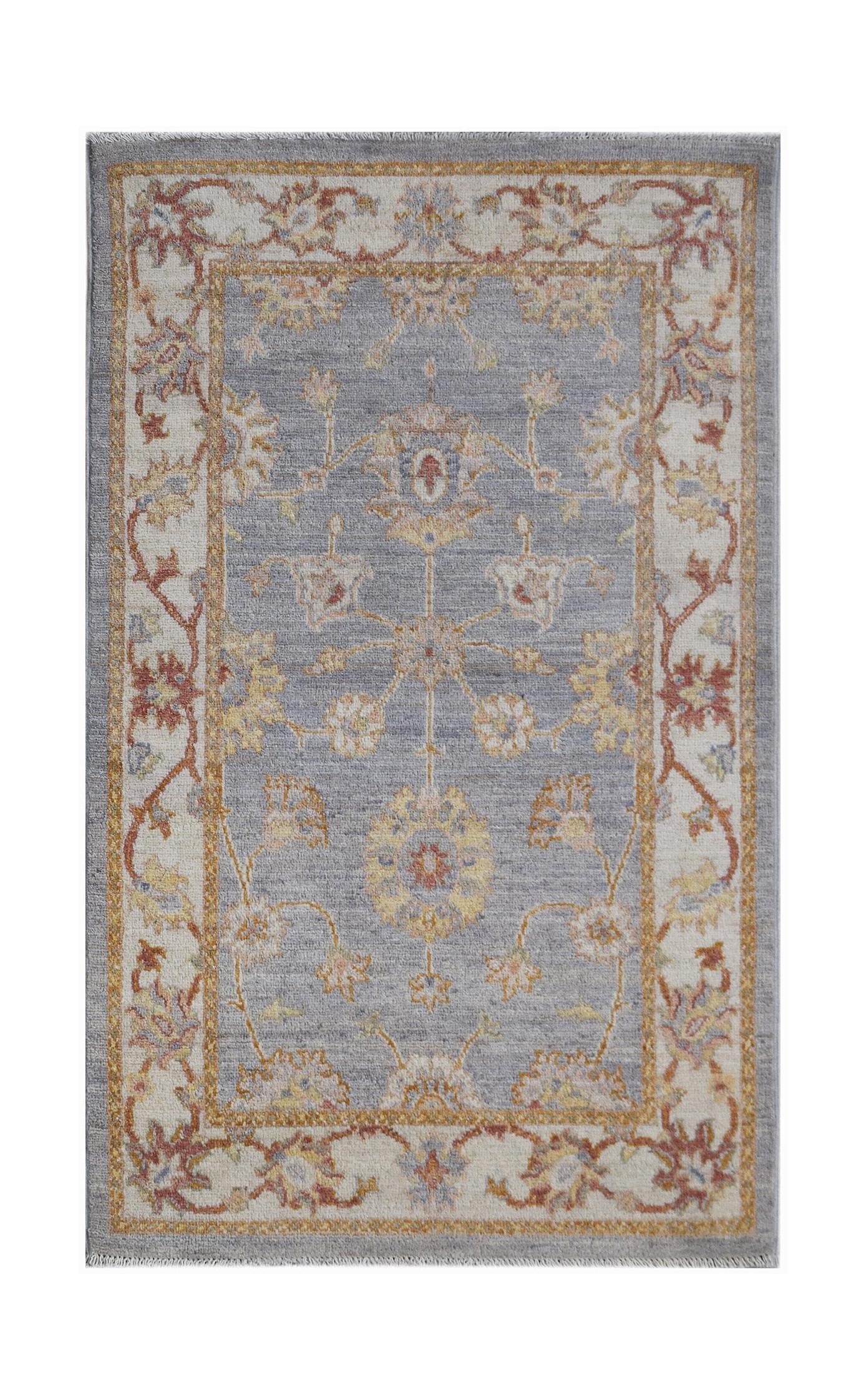 An Afghan Chobi rug featuring a traditional floral pattern in muted tones on a grey background.