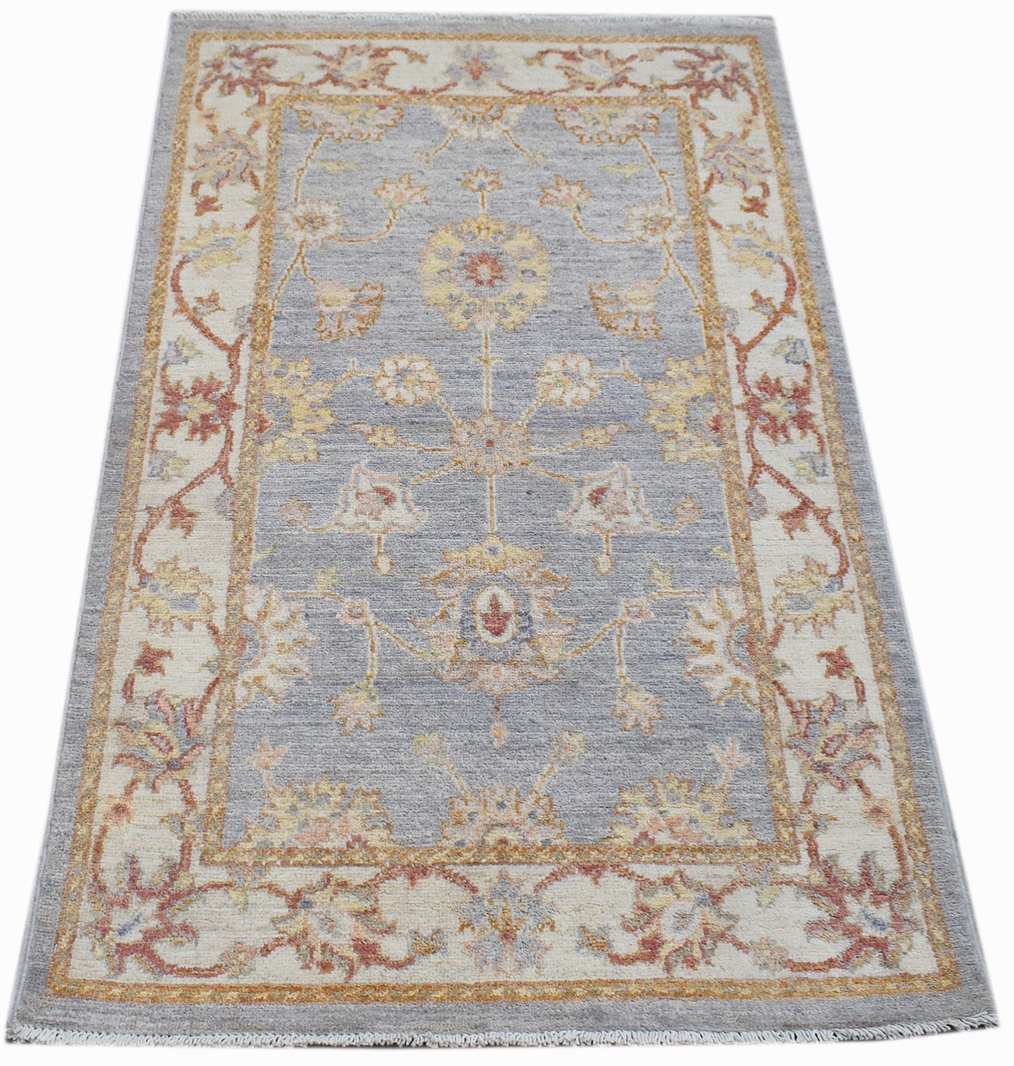 A rectangular Afghan Chobi rug featuring a traditional floral pattern in soft blue and cream tones.
