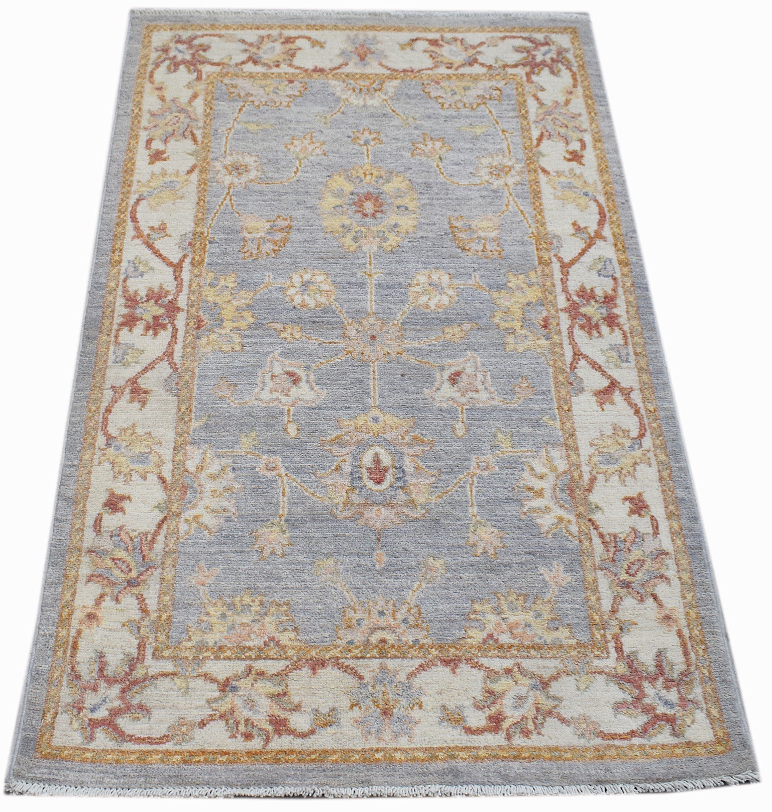 A rectangular Afghan Chobi rug featuring a traditional floral pattern in soft blue and cream tones.