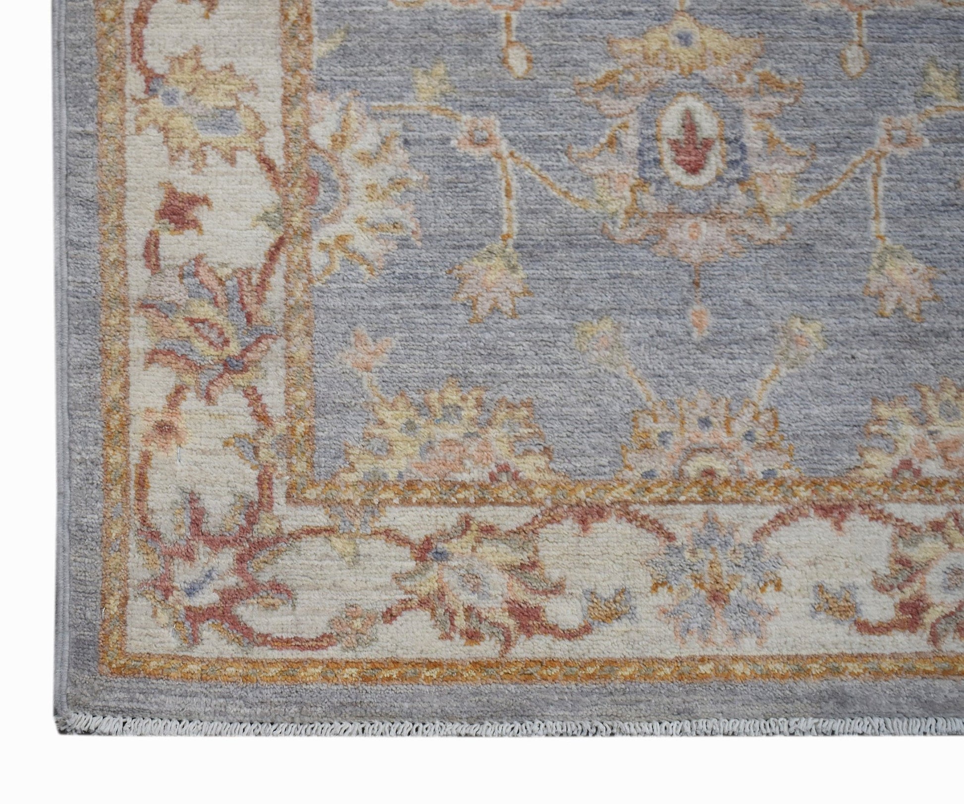 A handmade Afghan Chobi rug featuring a traditional floral pattern in soft blue and cream tones.