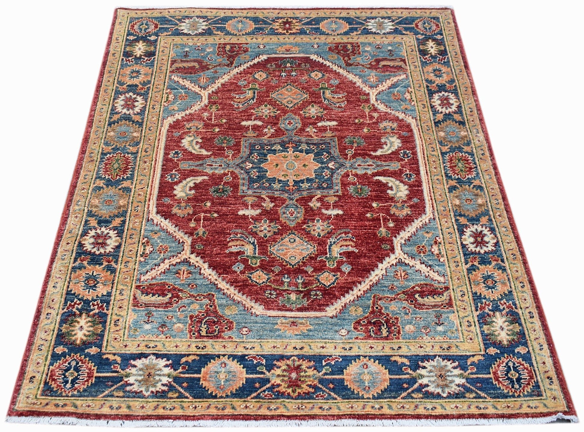 A rectangular Afghan Chobi rug featuring a central red medallion with intricate blue floral patterns.