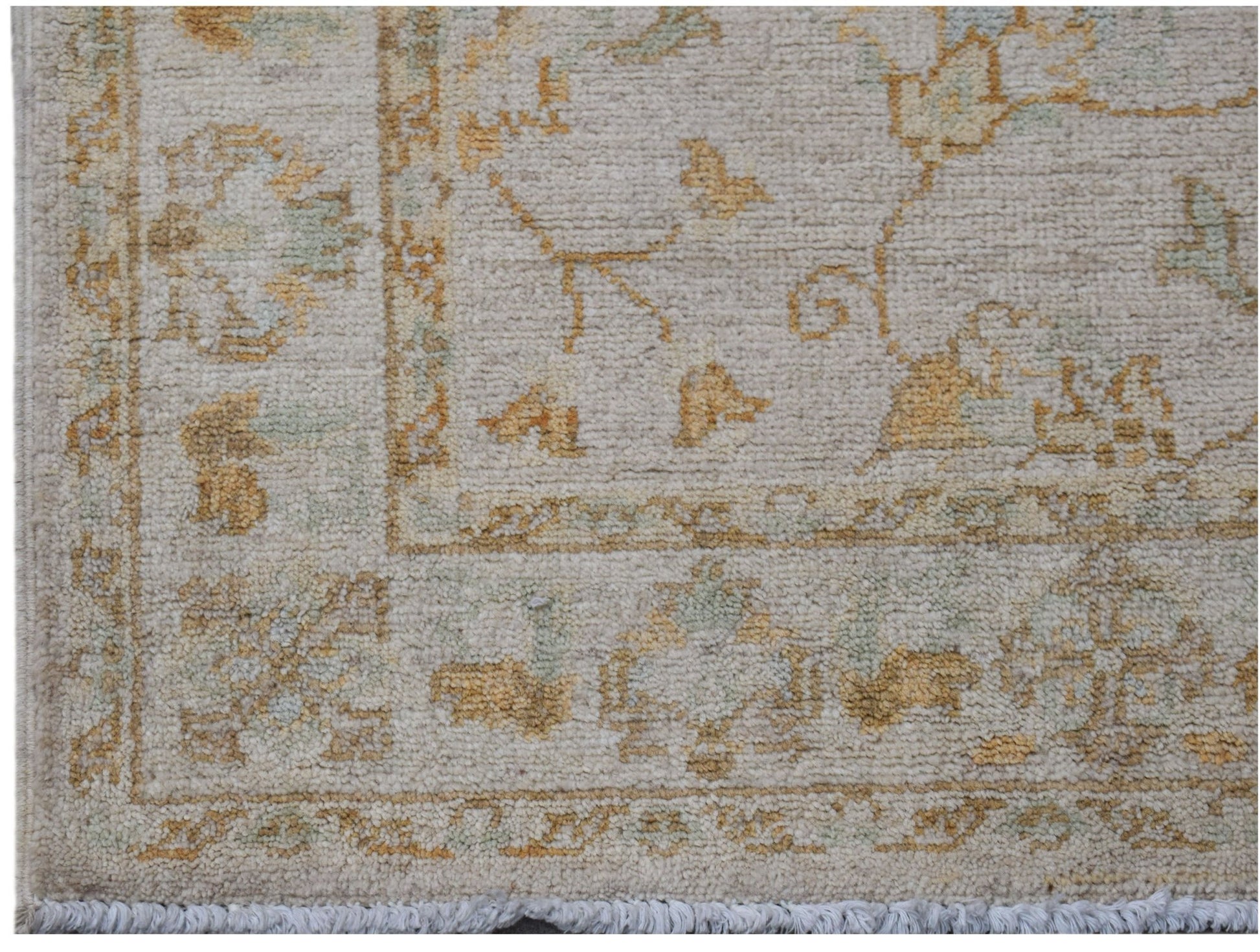 A handwoven Afghan Chobi rug featuring traditional floral patterns in soft beige and gold tones.