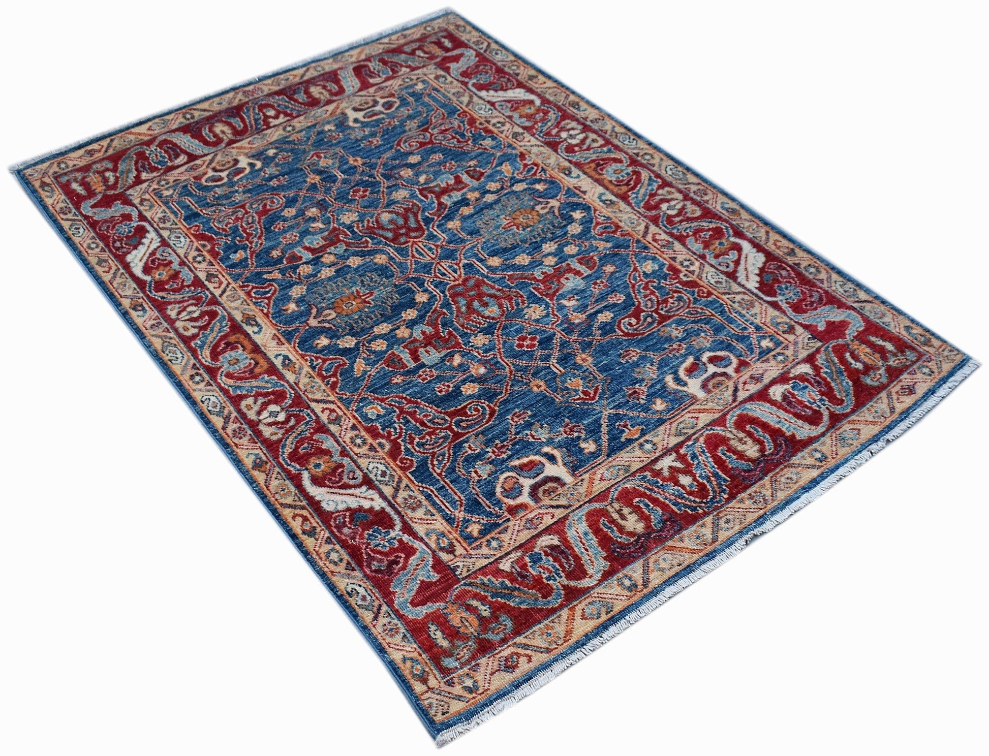 A rectangular Afghan Chobi rug featuring a traditional floral pattern in blue and red tones.
