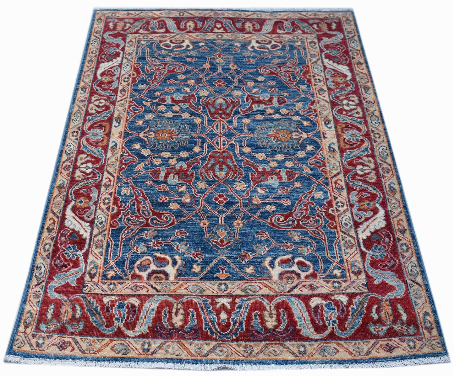 A rectangular Afghan Chobi rug featuring a traditional floral pattern in blue, red, and beige.