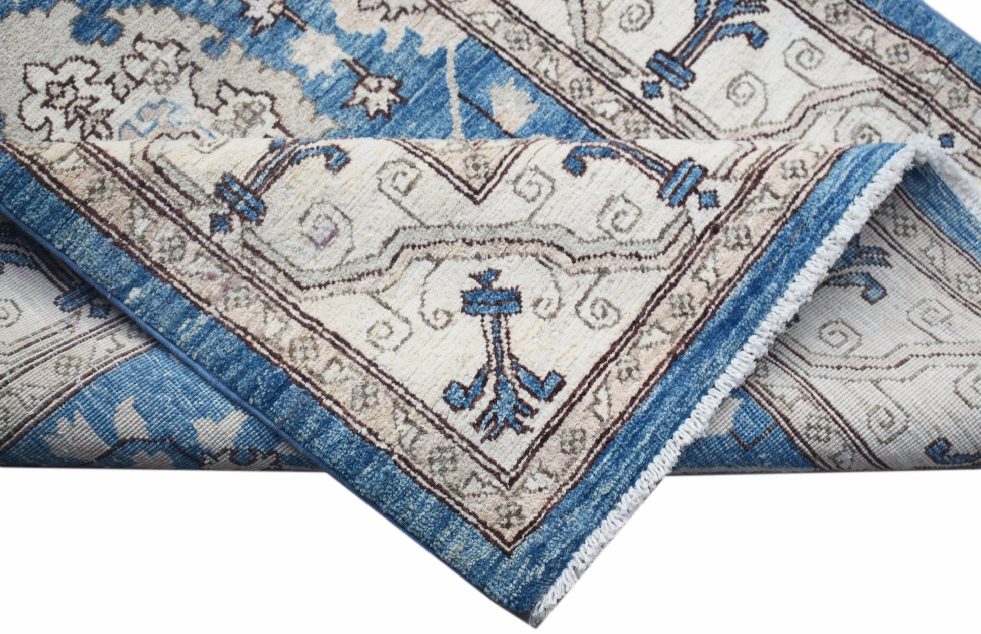 A handwoven Afghan Chobi rug featuring a traditional blue and cream floral pattern.