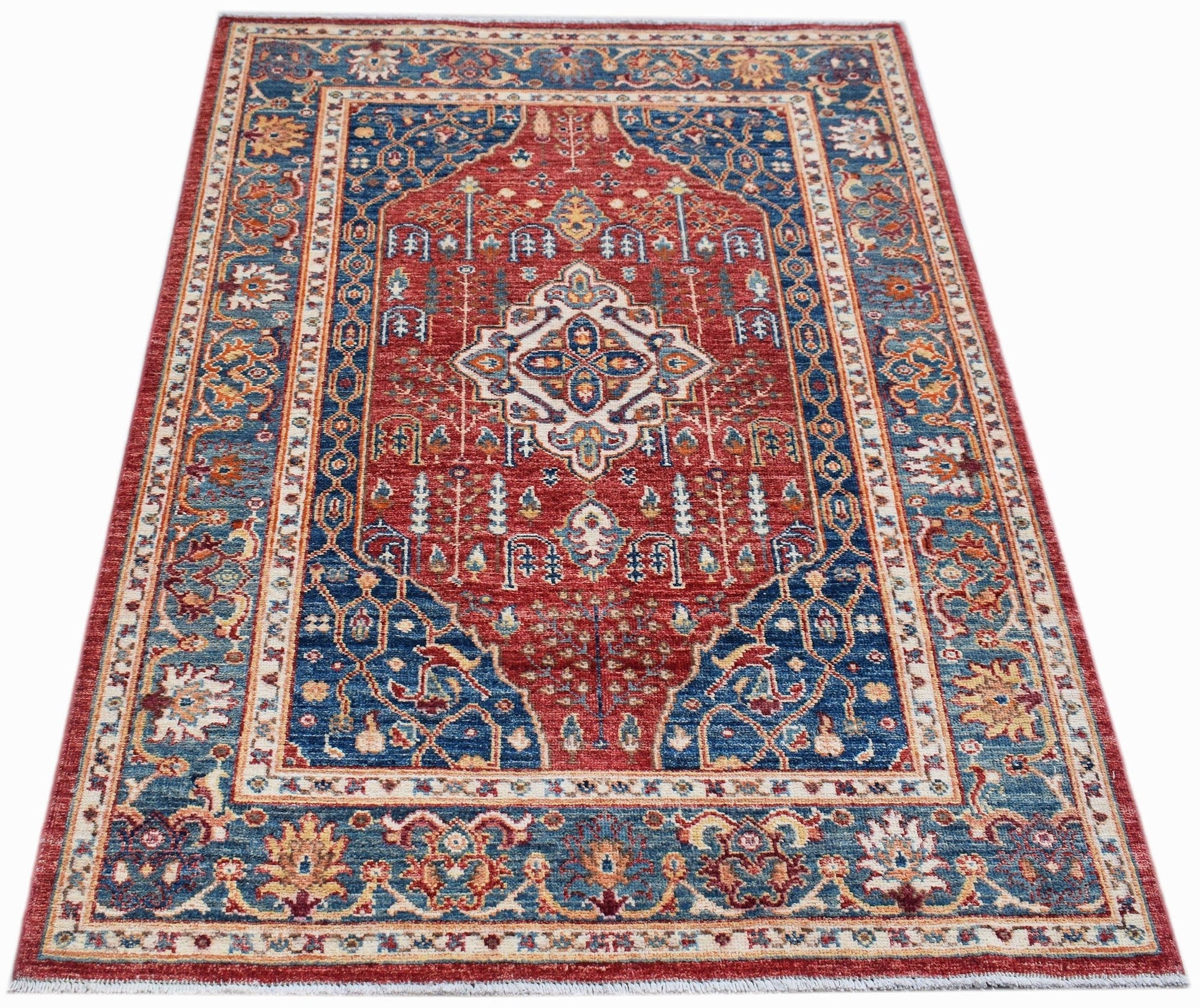 Handmade Afghan Chobi rug featuring a traditional Heriz pattern in red and blue wool.