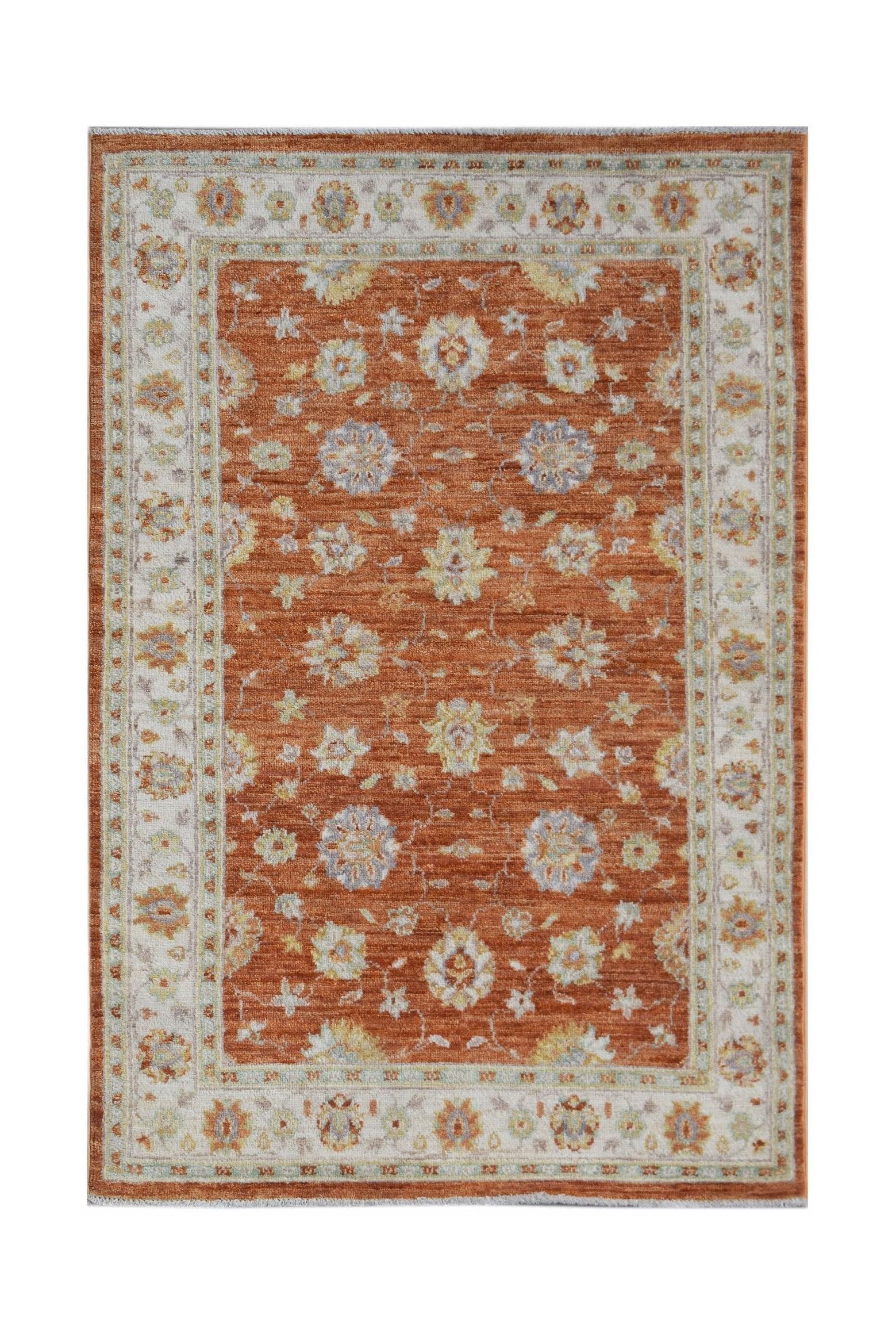 A rectangular Afghan Chobi rug featuring a rust-orange field with a traditional floral pattern.