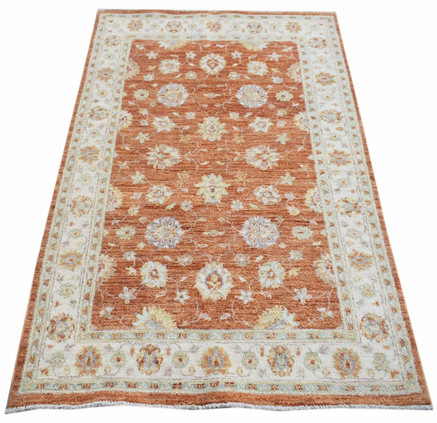 A rectangular Afghan Chobi rug featuring a floral pattern in rust orange and cream tones.