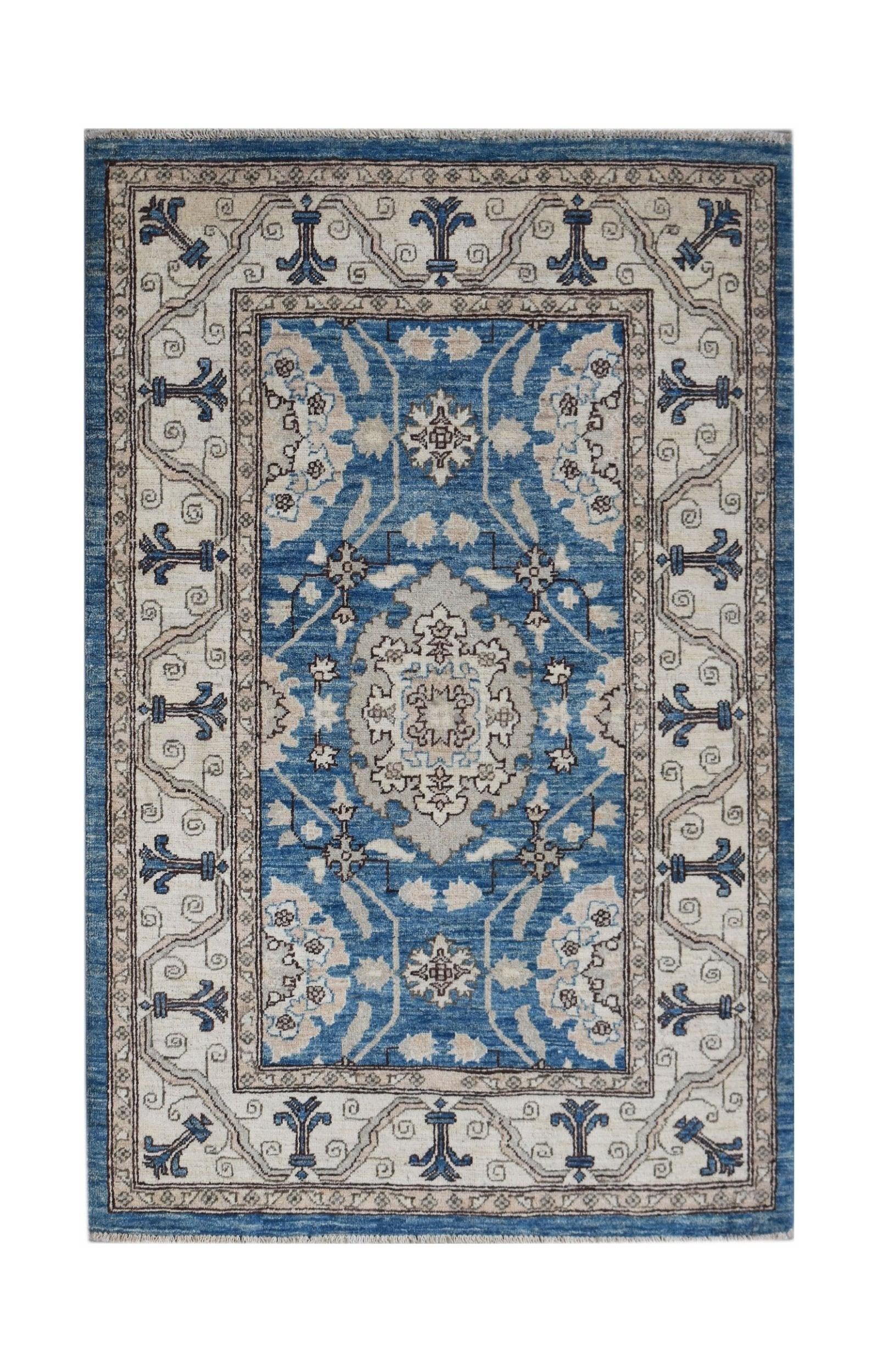 Handwoven Afghan Chobi rug featuring a traditional blue and beige floral medallion pattern.