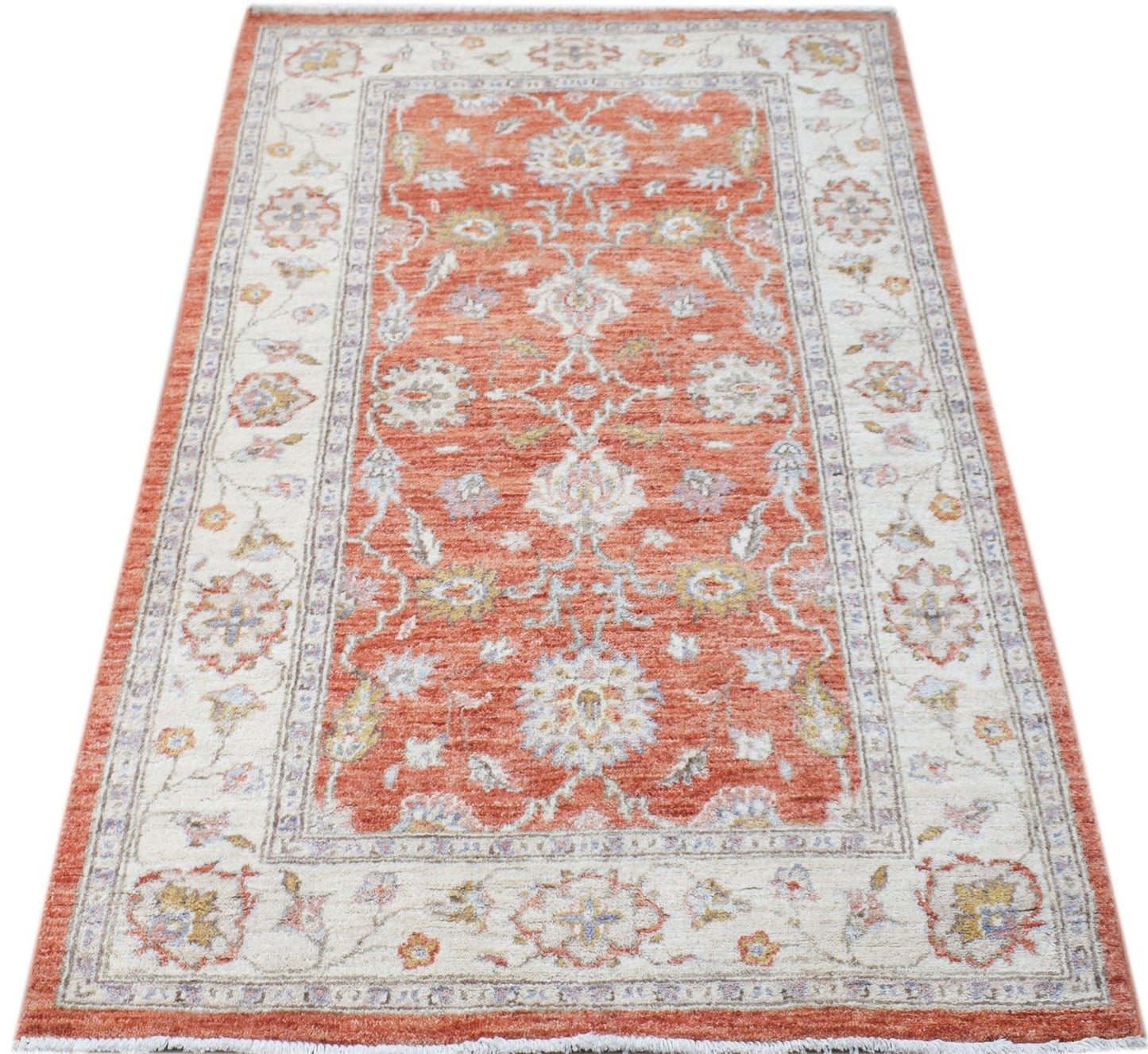 A rectangular Afghan Chobi rug featuring a traditional floral pattern in orange and cream tones.