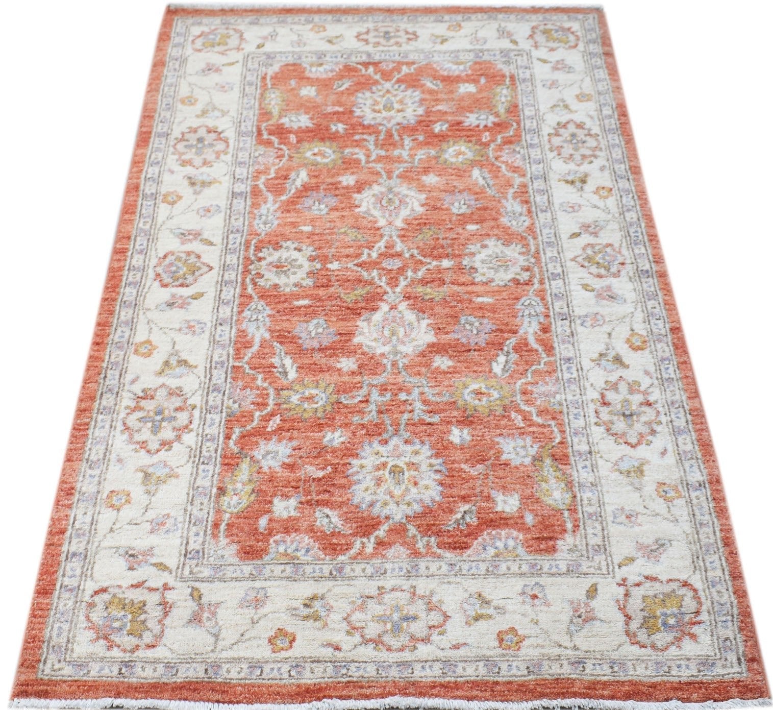 A rectangular Afghan Chobi rug featuring a traditional floral pattern in orange and cream tones.