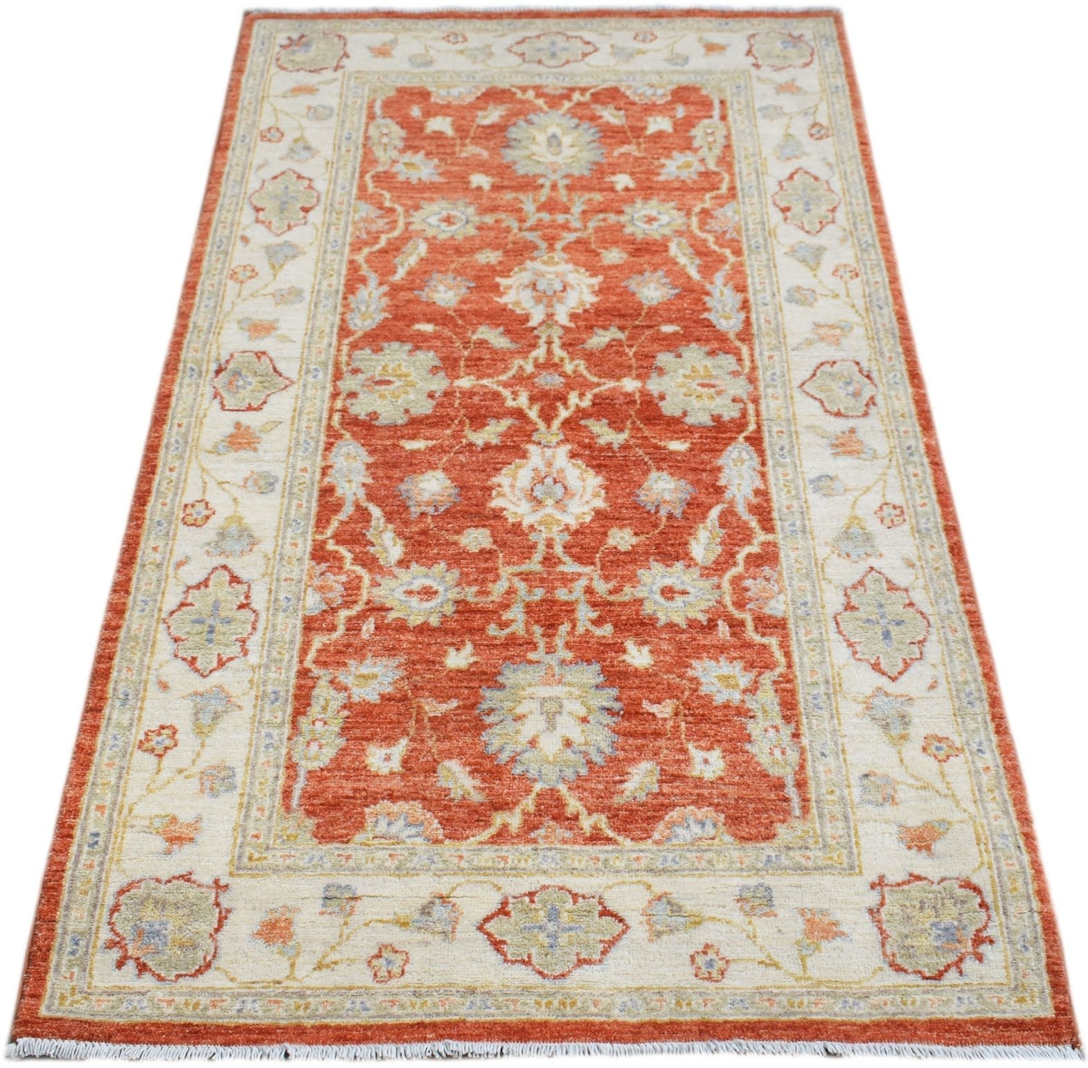 Handwoven Afghan Chobi rug featuring a traditional floral pattern in rust orange and cream tones.