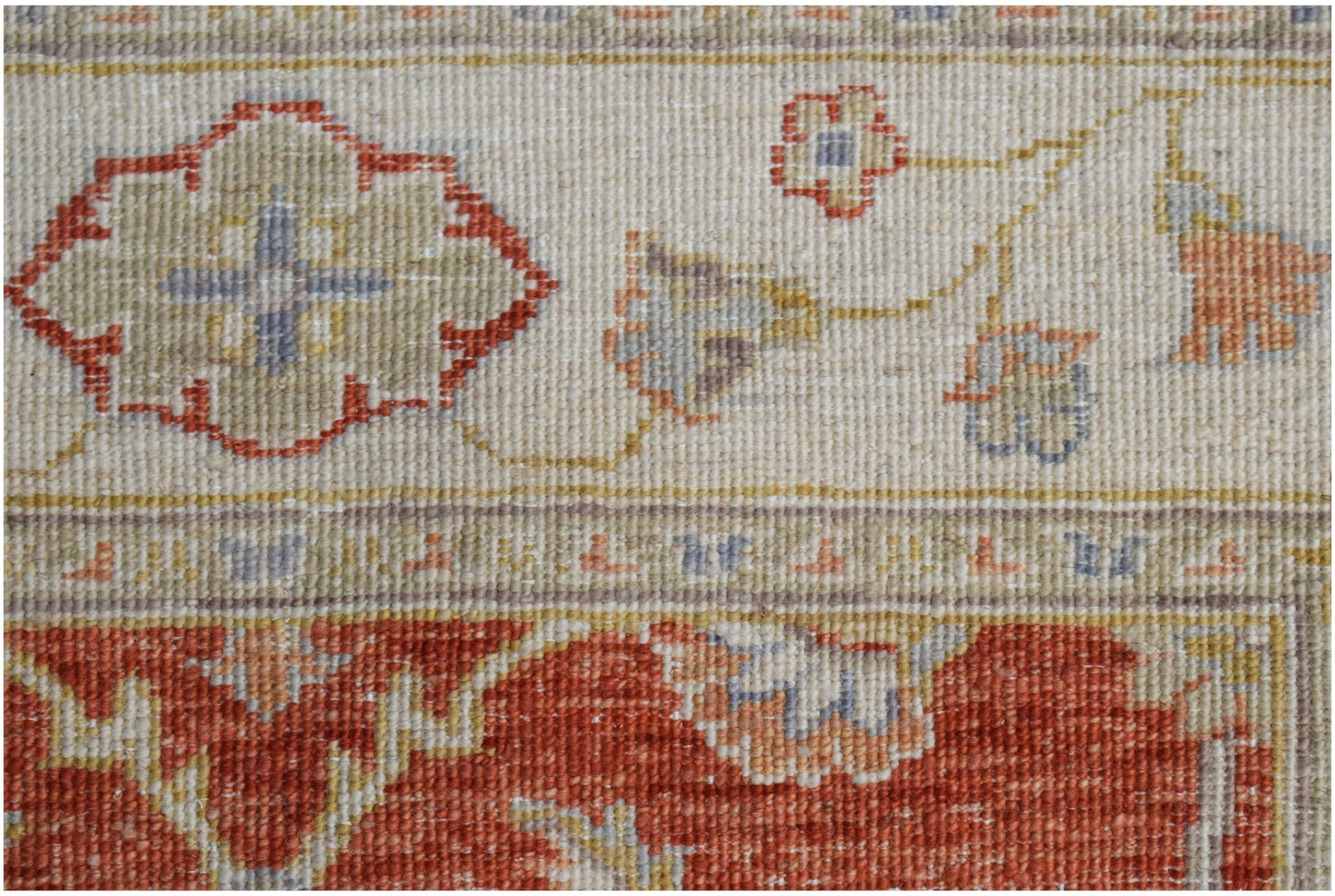 A close-up of an Afghan Chobi rug featuring a floral pattern in rust, beige, and blue tones.