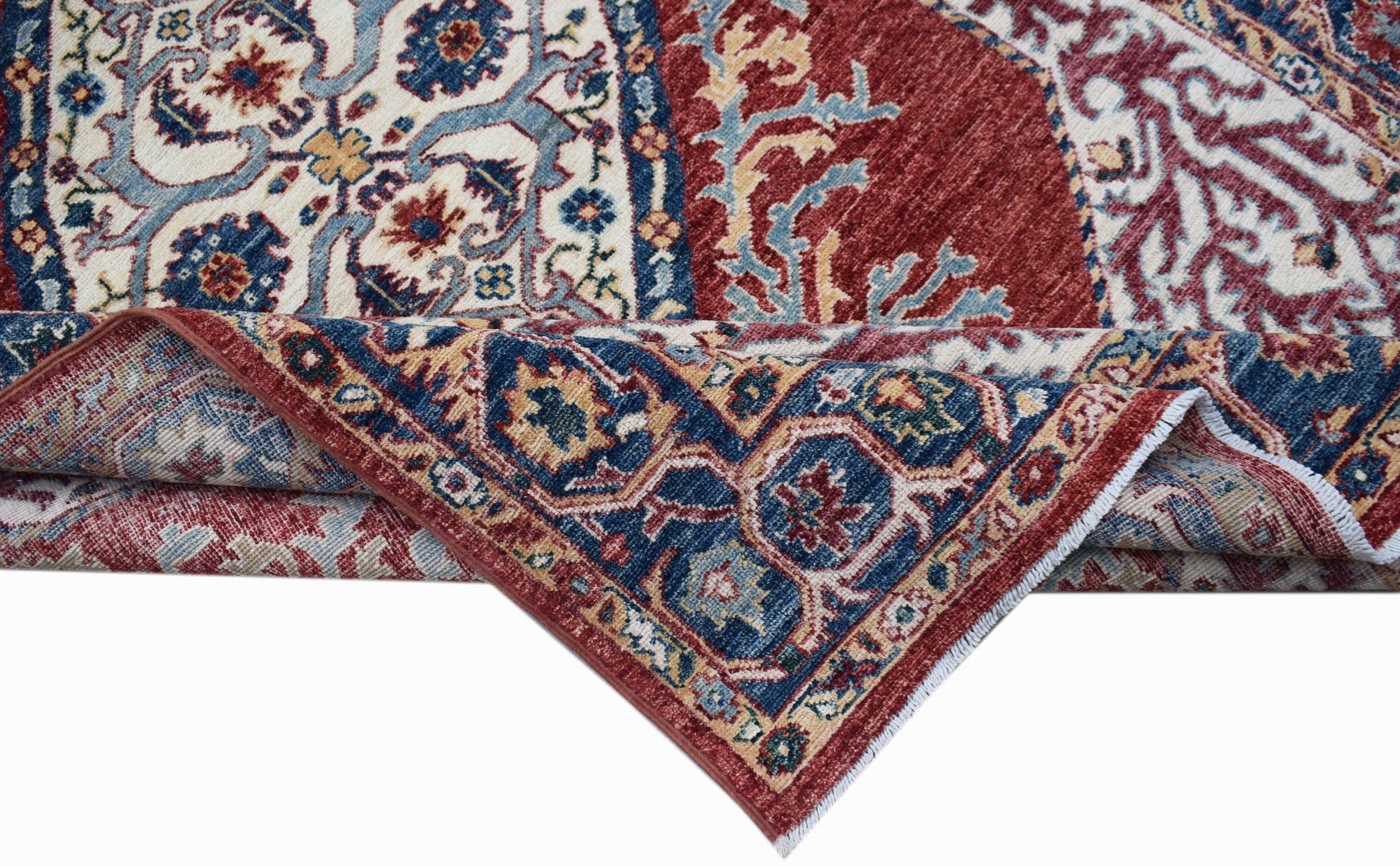 A handwoven Afghan Chobi rug featuring a traditional Heriz pattern in red, blue, and cream tones.