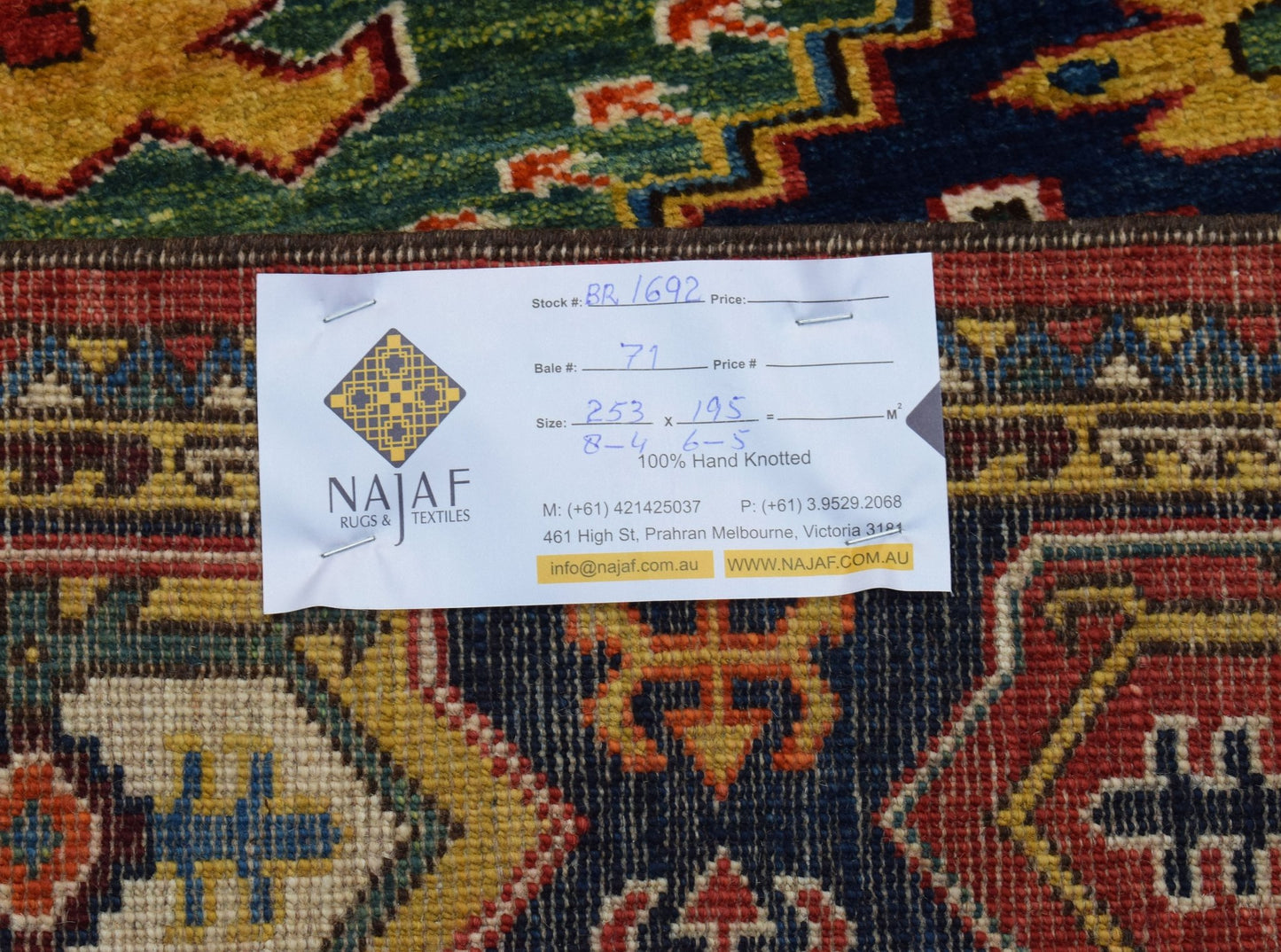 A handmade Afghan Chobi rug featuring a traditional geometric pattern in rich, earthy tones.
