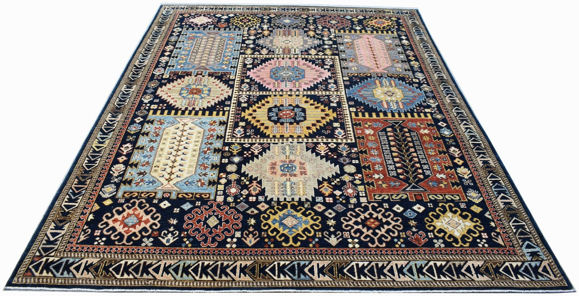 A rectangular Afghan Chobi rug featuring a dark blue field with colorful geometric medallions.