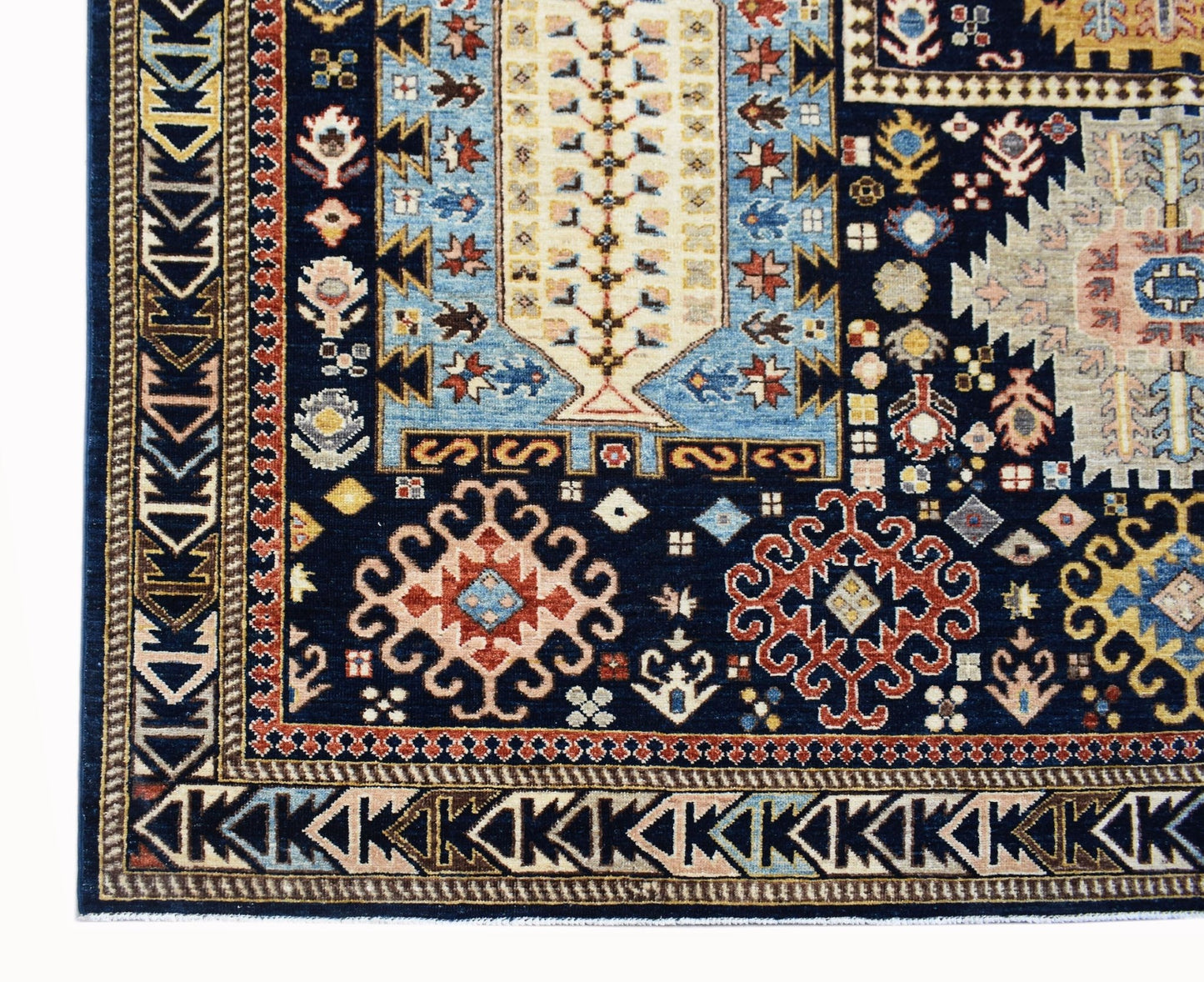 A handmade Afghan Chobi rug featuring intricate geometric patterns in blue, red, and cream tones.