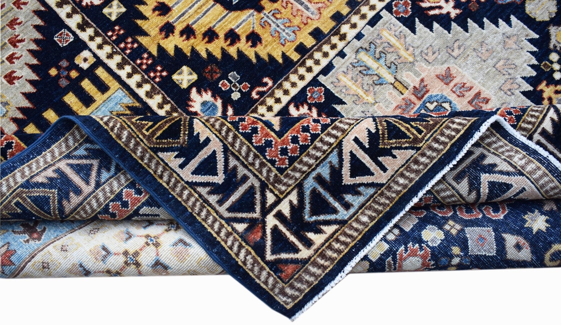 A handwoven Afghan Chobi rug featuring intricate geometric patterns in blue, gold, and cream tones.