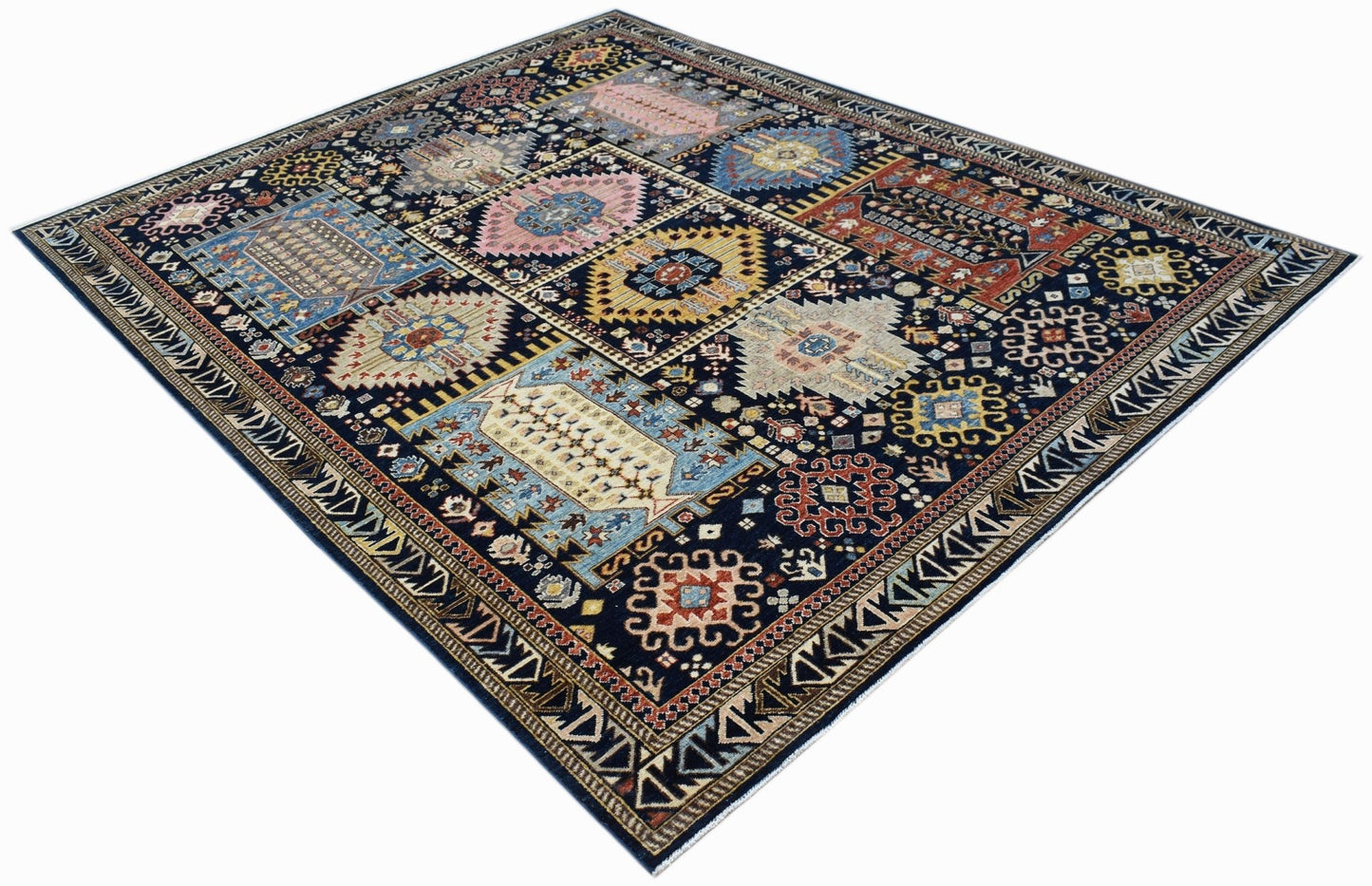 A rectangular Afghan Chobi rug featuring a dark blue field with geometric, multi-colored motifs.