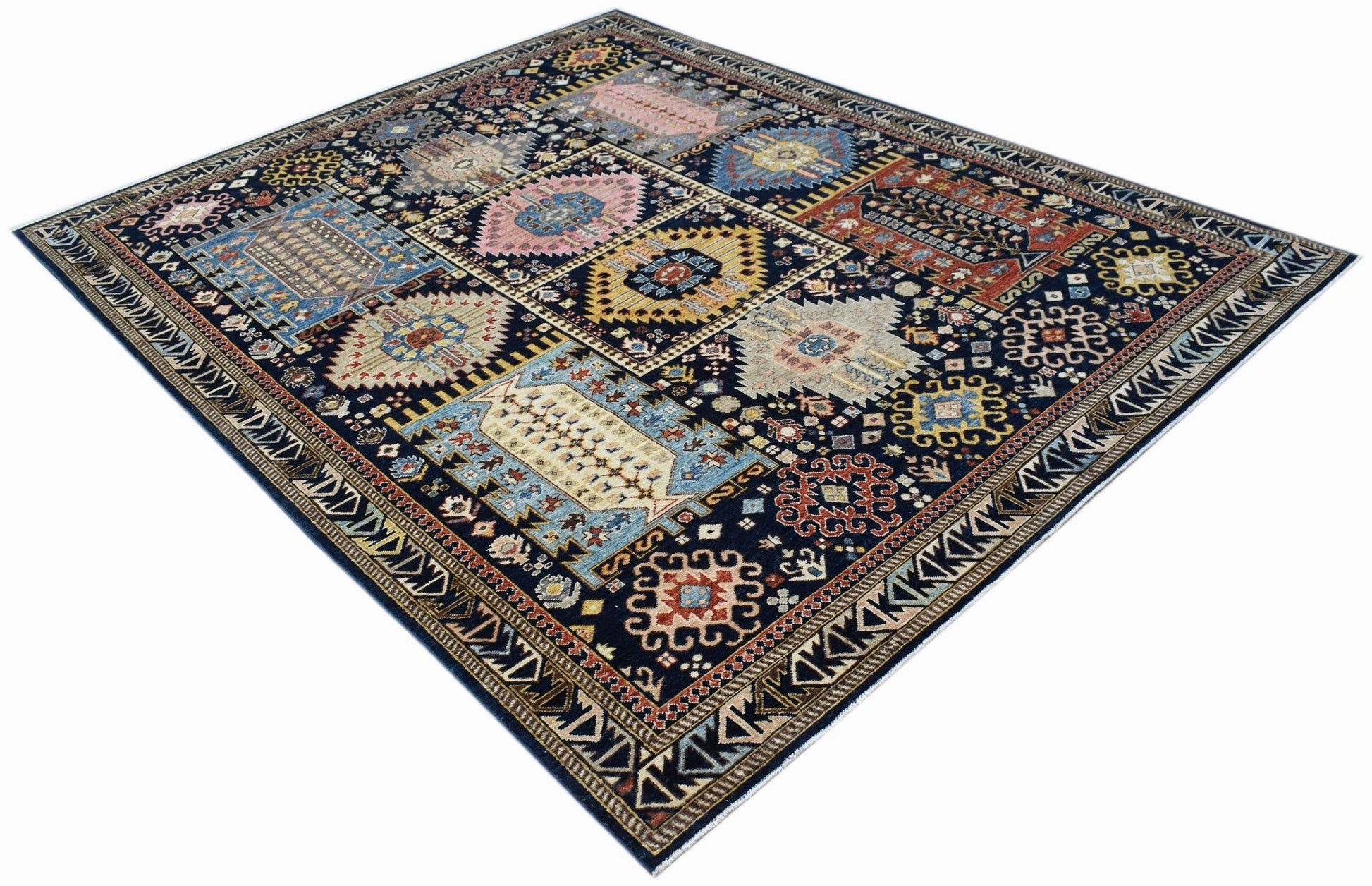 A rectangular Afghan Chobi rug featuring a dark blue field with geometric, multi-colored motifs.