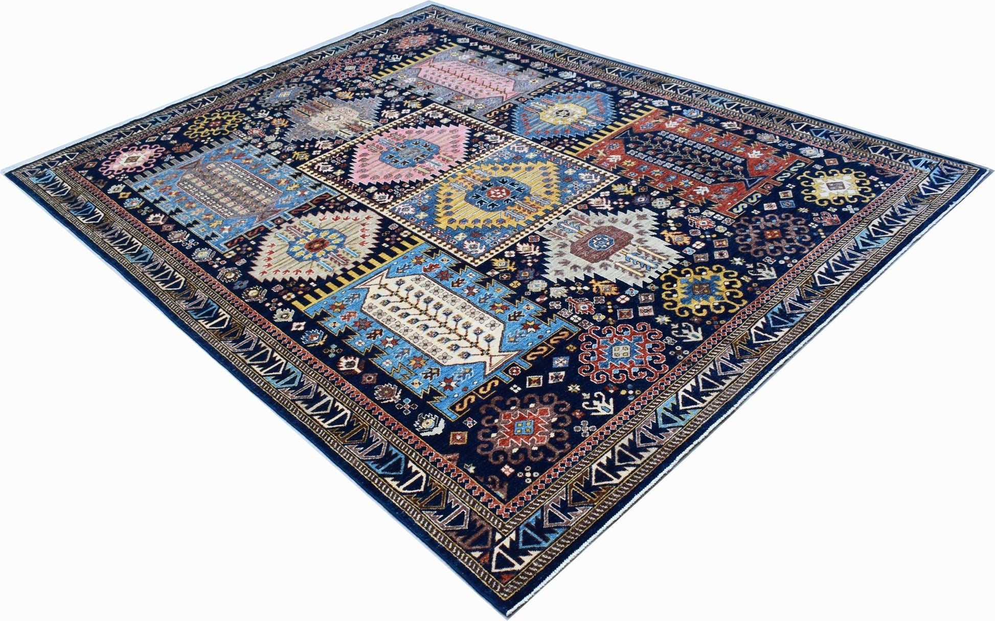A rectangular Afghan Chobi rug featuring a dark blue field with colorful geometric medallions.