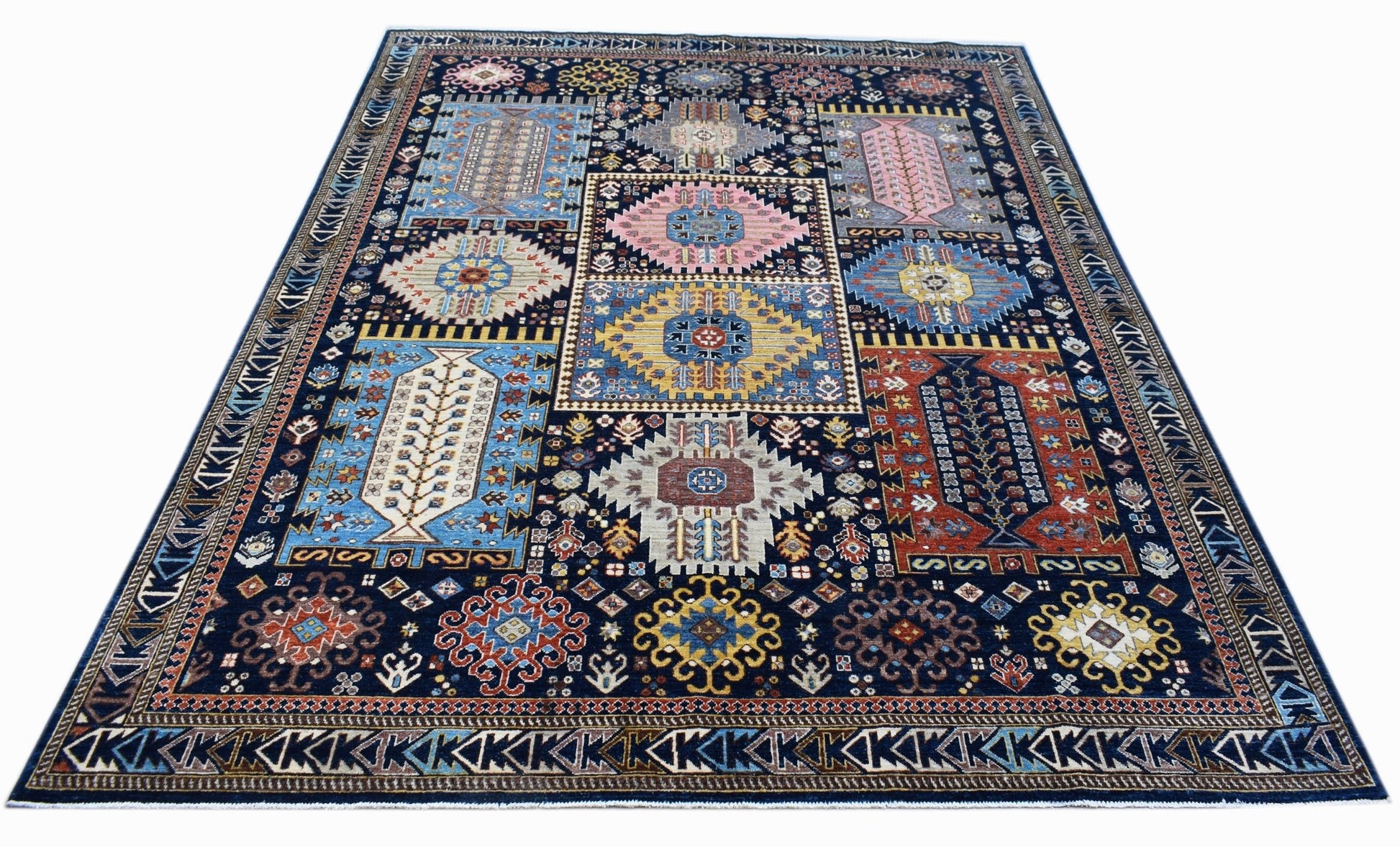 A rectangular Afghan Chobi rug featuring a dark blue field with colorful geometric patterns.