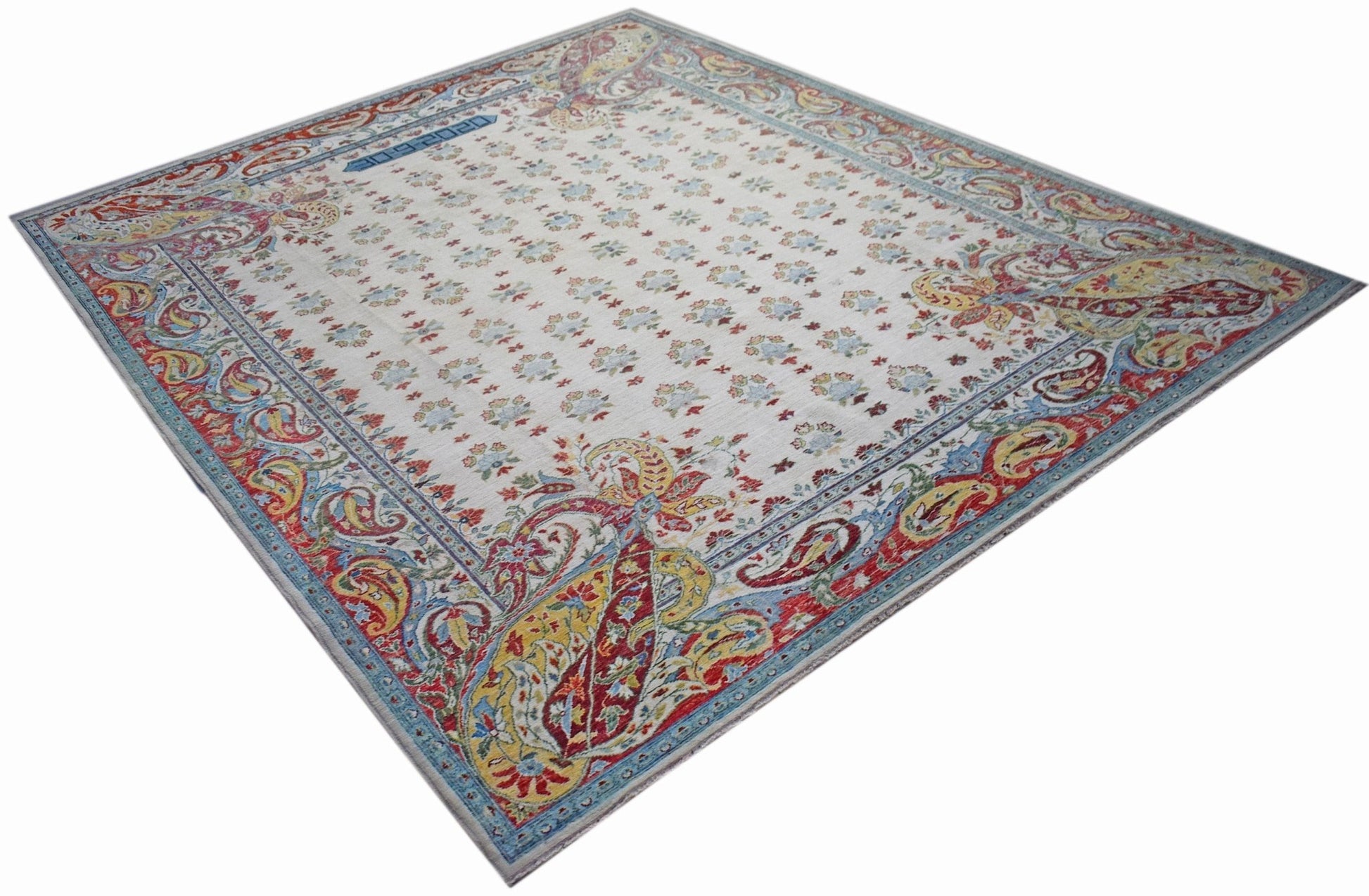 An Afghan Chobi rug featuring a cream field with floral motifs and a vibrant paisley border.