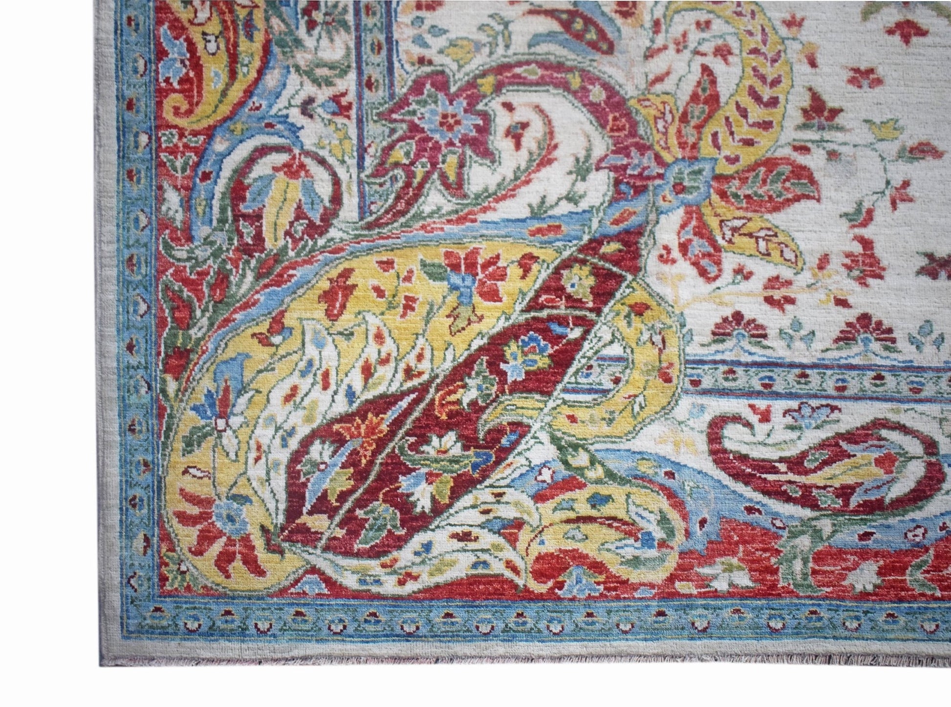 A corner view of a handwoven Afghan Chobi rug featuring a traditional paisley pattern in vibrant colors.