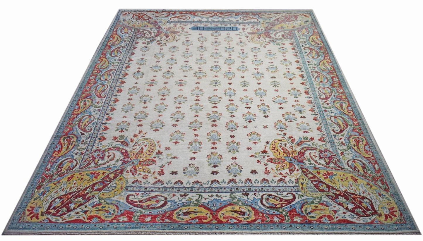 An Afghan Chobi rug featuring a cream field with floral motifs and a colorful paisley border.