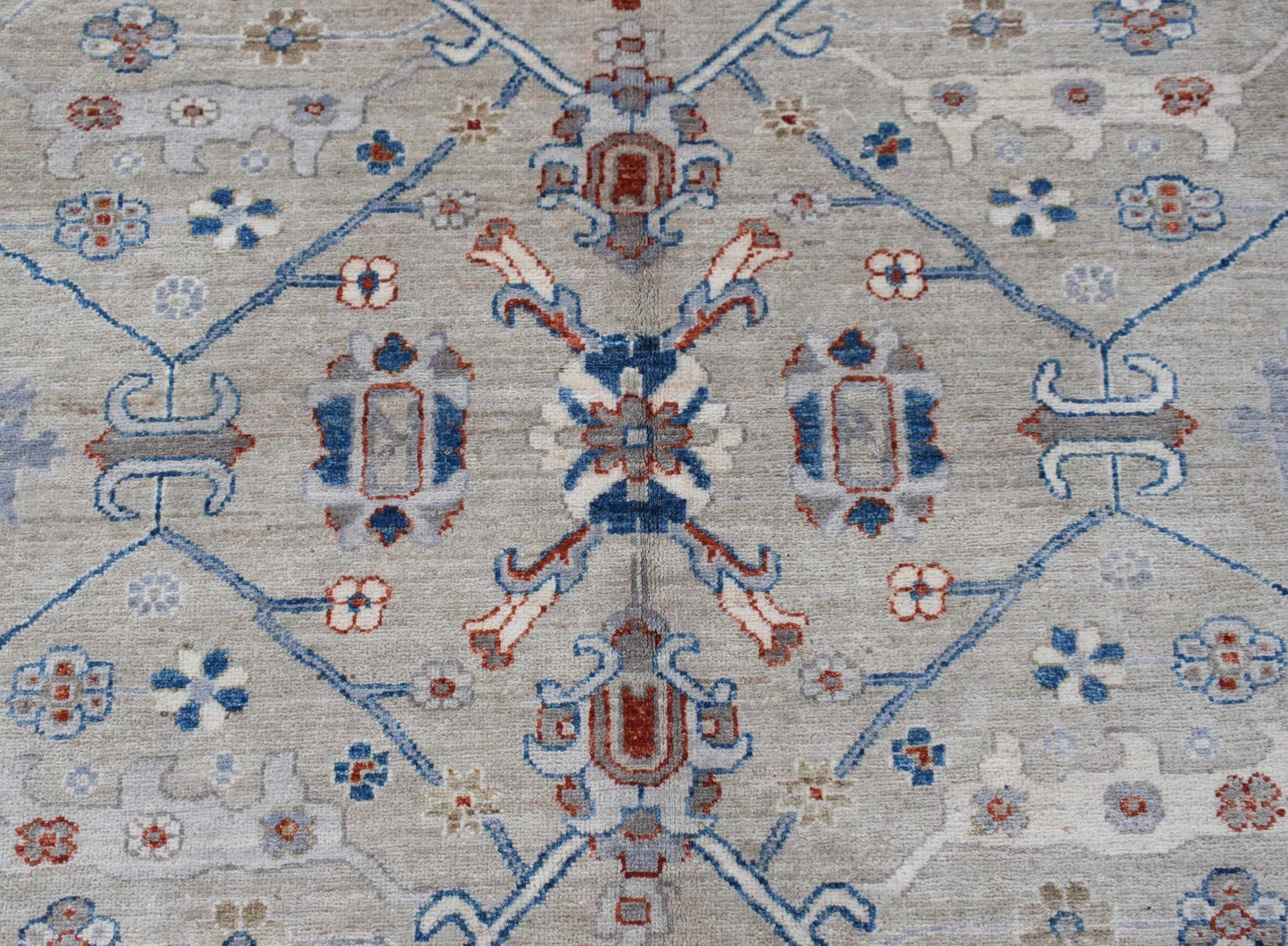 Handwoven Afghan Chobi rug featuring a traditional floral pattern in blue, red, and beige tones.