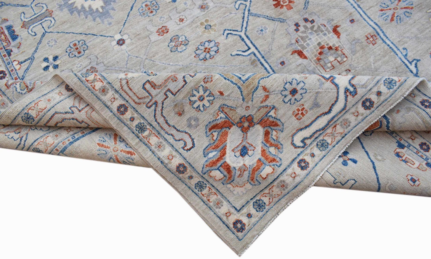 A handwoven Afghan Chobi rug featuring a light grey field with blue and rust floral patterns.