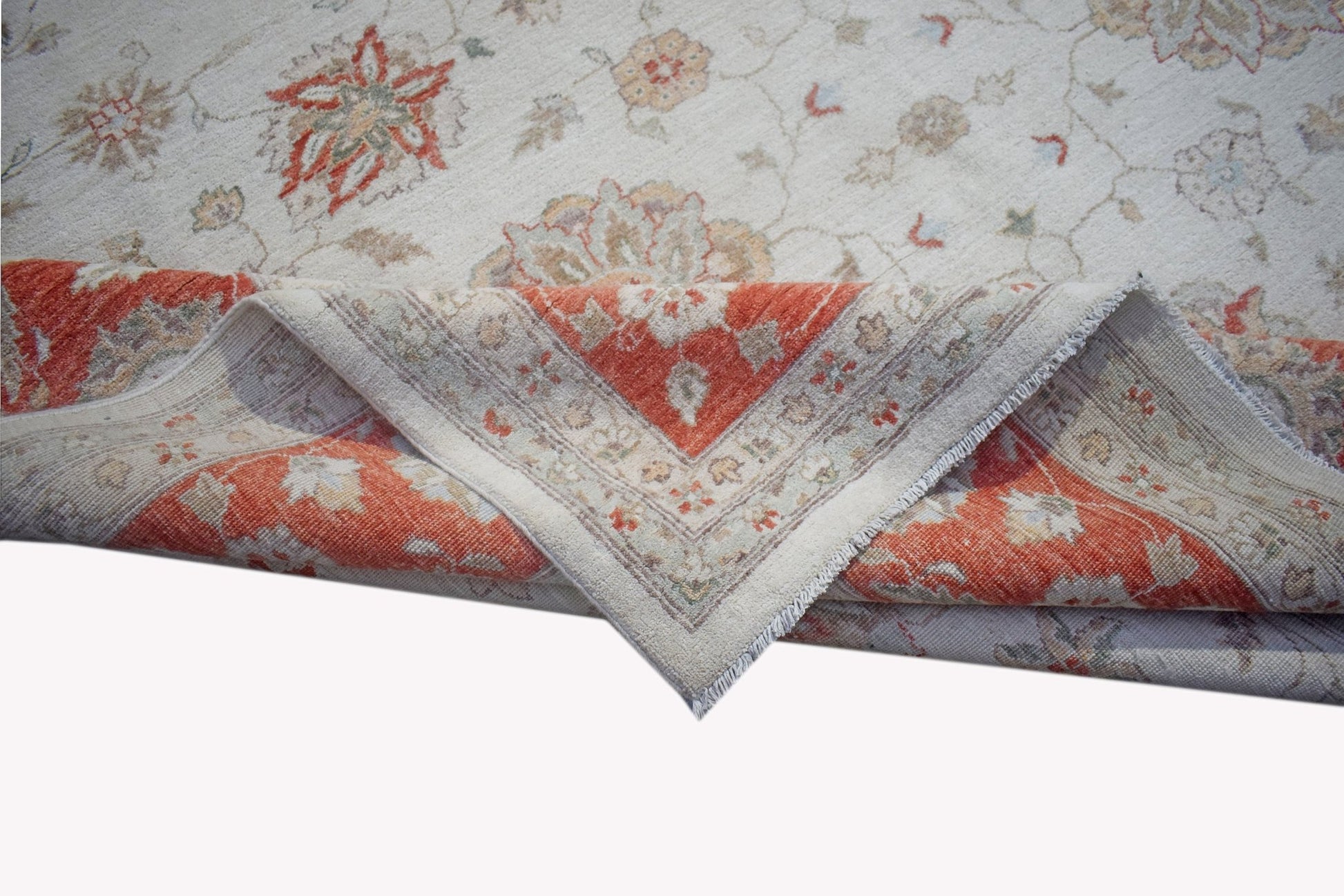 A handwoven Afghan Chobi rug featuring a floral pattern in orange and beige tones.