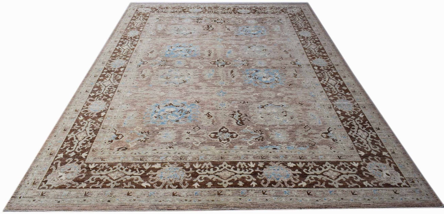 A handmade transitional Oushak rug featuring a brown and blue patterned design on wool.