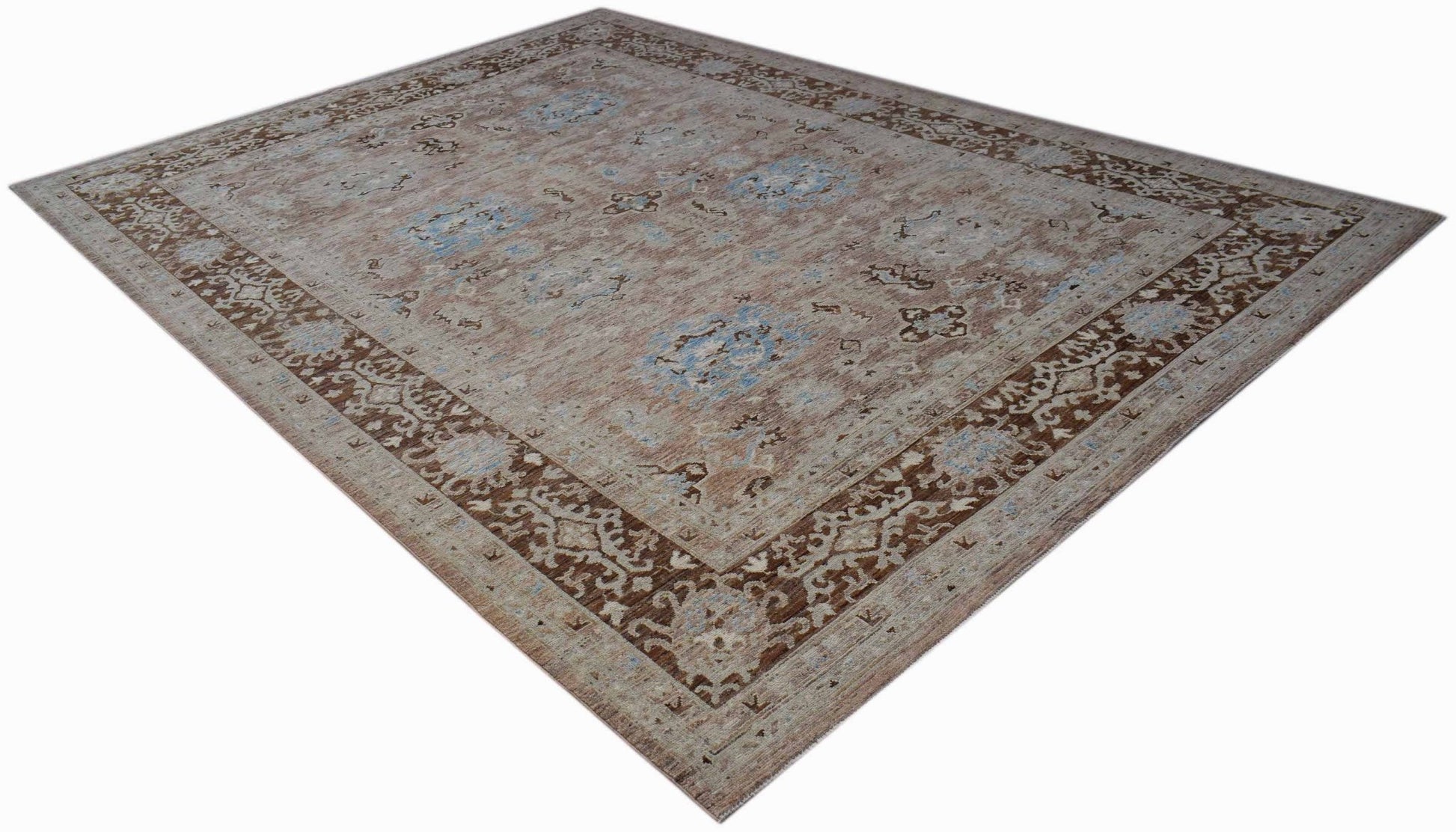 A rectangular transitional Oushak rug featuring a brown and blue floral pattern on a beige field.