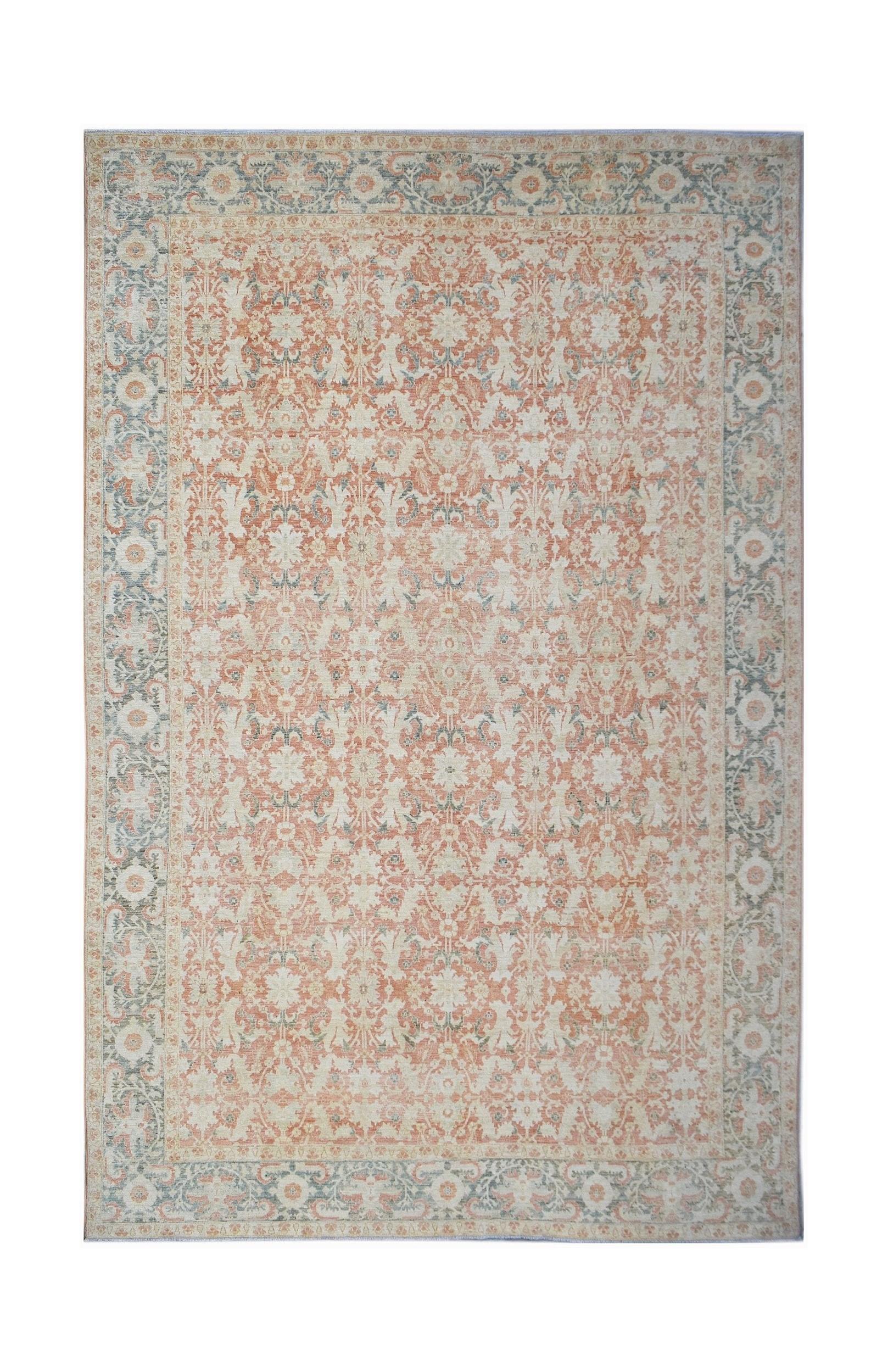 An Afghan Balkh rug featuring a traditional floral pattern in soft peach and muted blue tones.