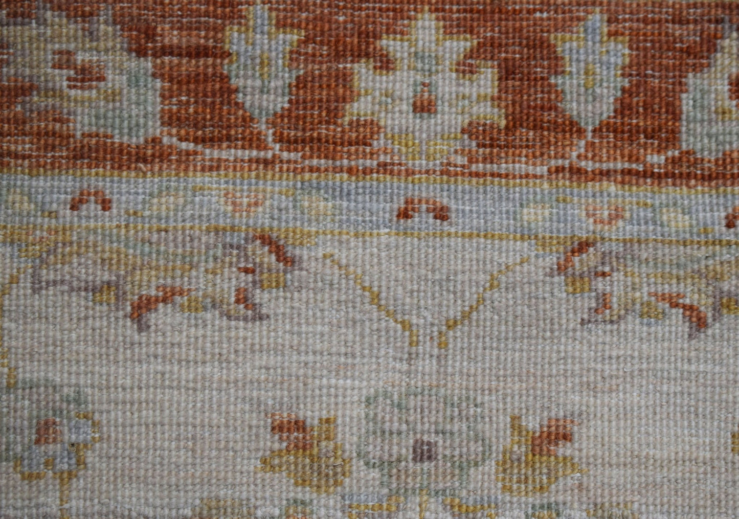 A close-up of an Afghan Chobi runner featuring traditional floral patterns in earthy tones.