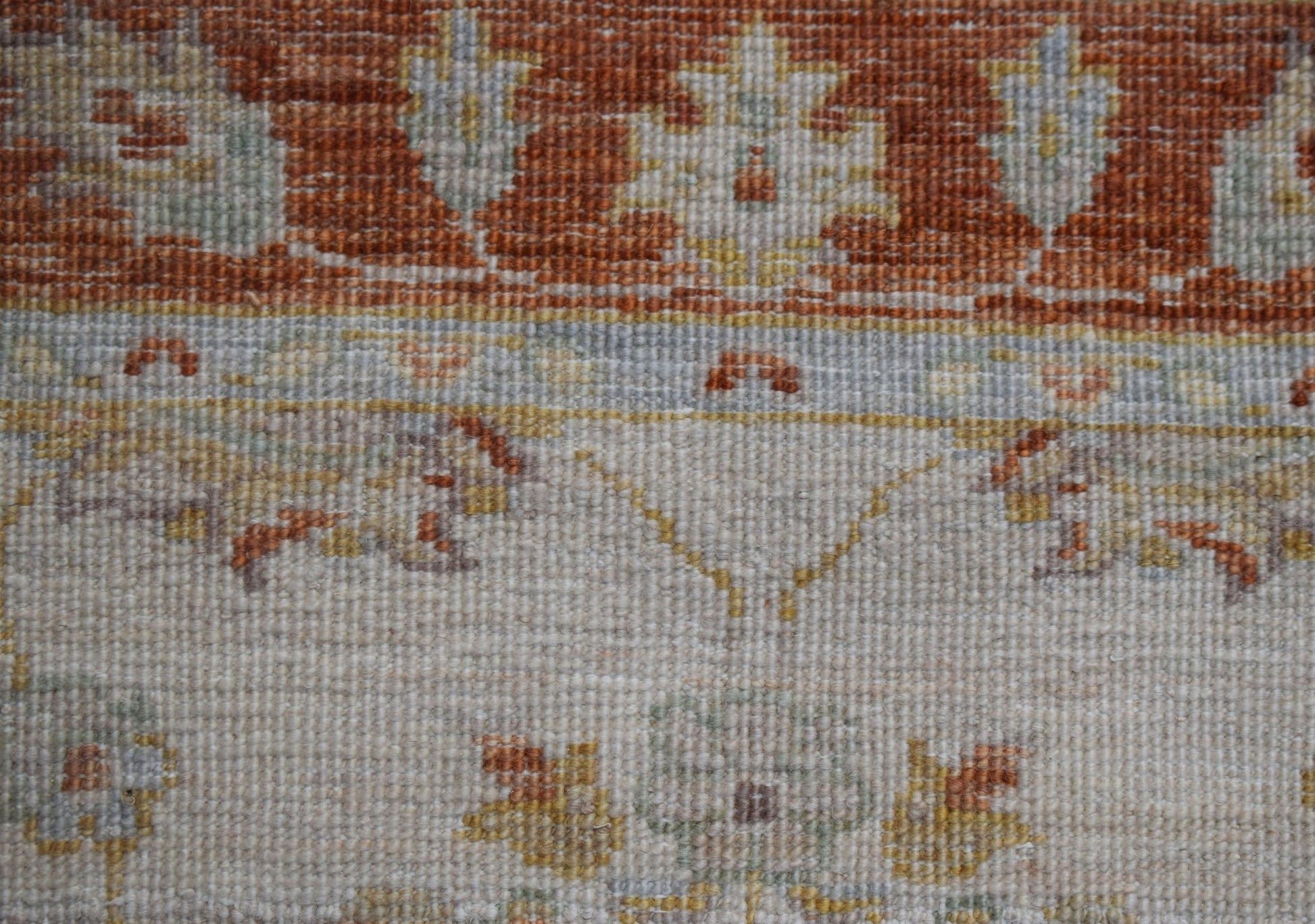 A close-up of an Afghan Chobi runner featuring traditional floral patterns in earthy tones.