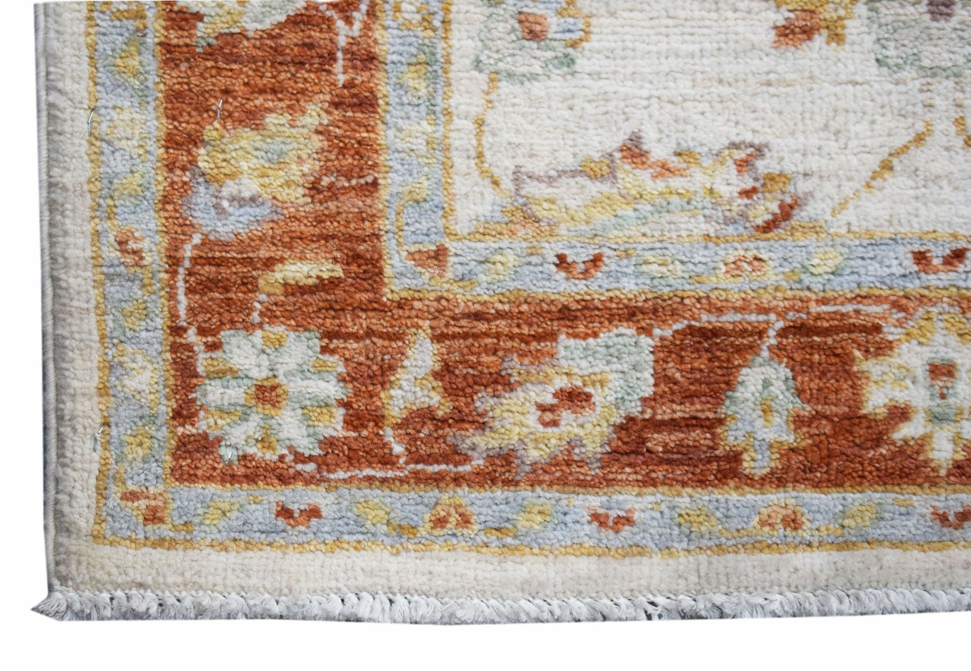 A handmade Afghan Chobi runner featuring a traditional floral pattern in rust and cream tones.