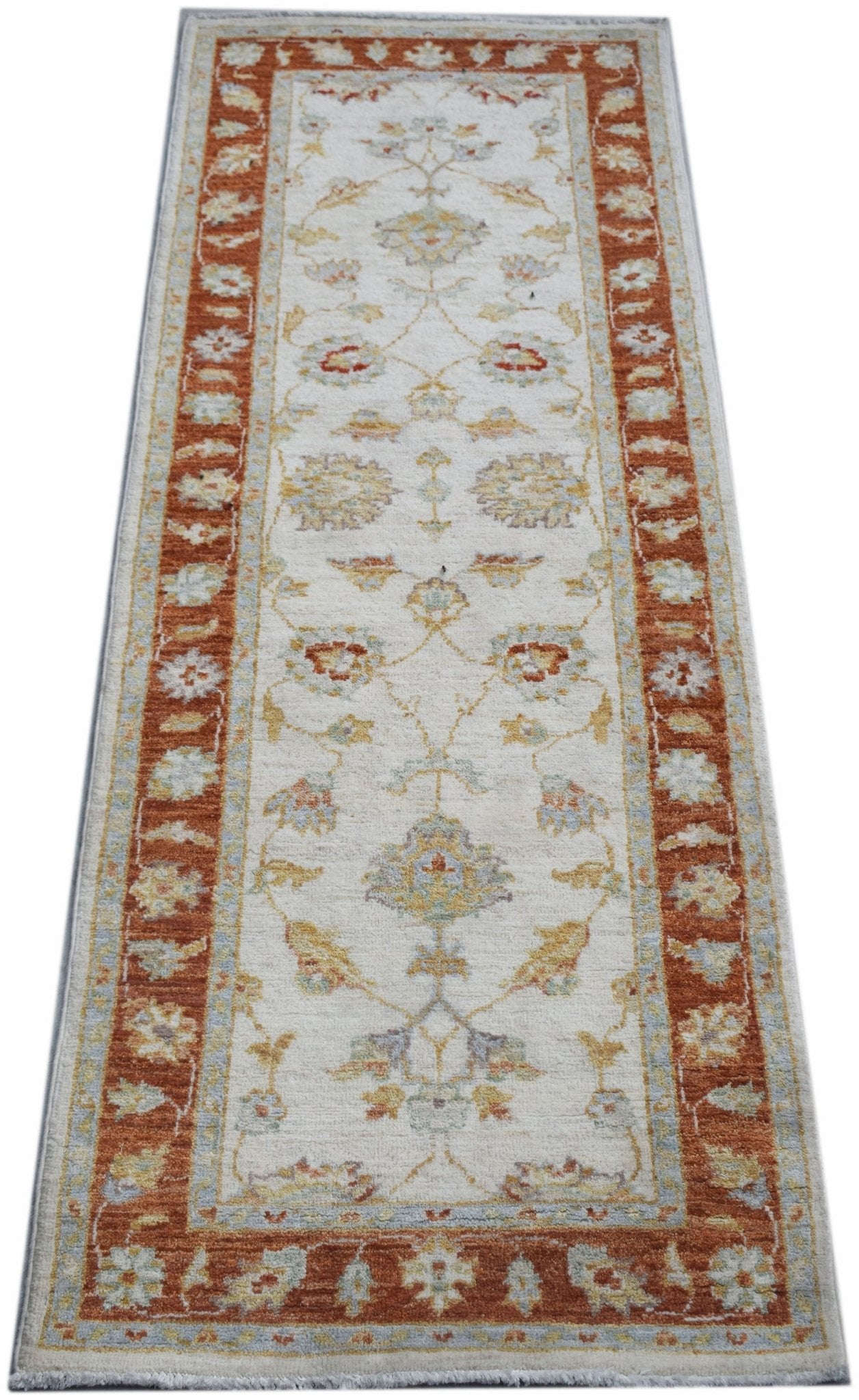 An Afghan Chobi runner rug featuring a traditional floral pattern in rust and cream tones.