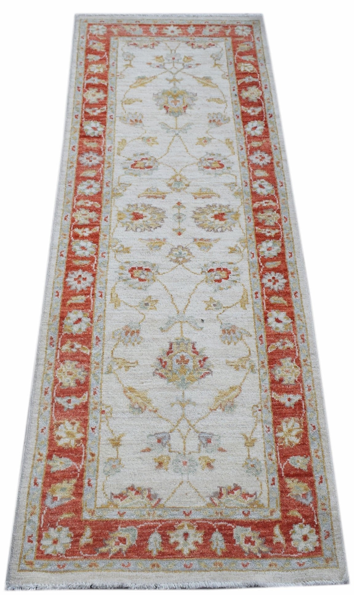 A handmade Afghan Chobi runner rug featuring a traditional floral pattern in red and cream tones.